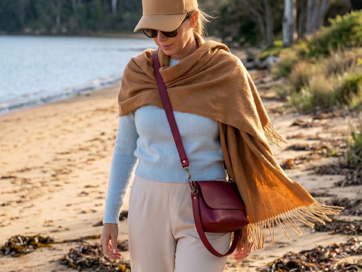 Model wearing an Orange Inca baby alpaca jumper and shawl with the Olivia leather crossbody bag
