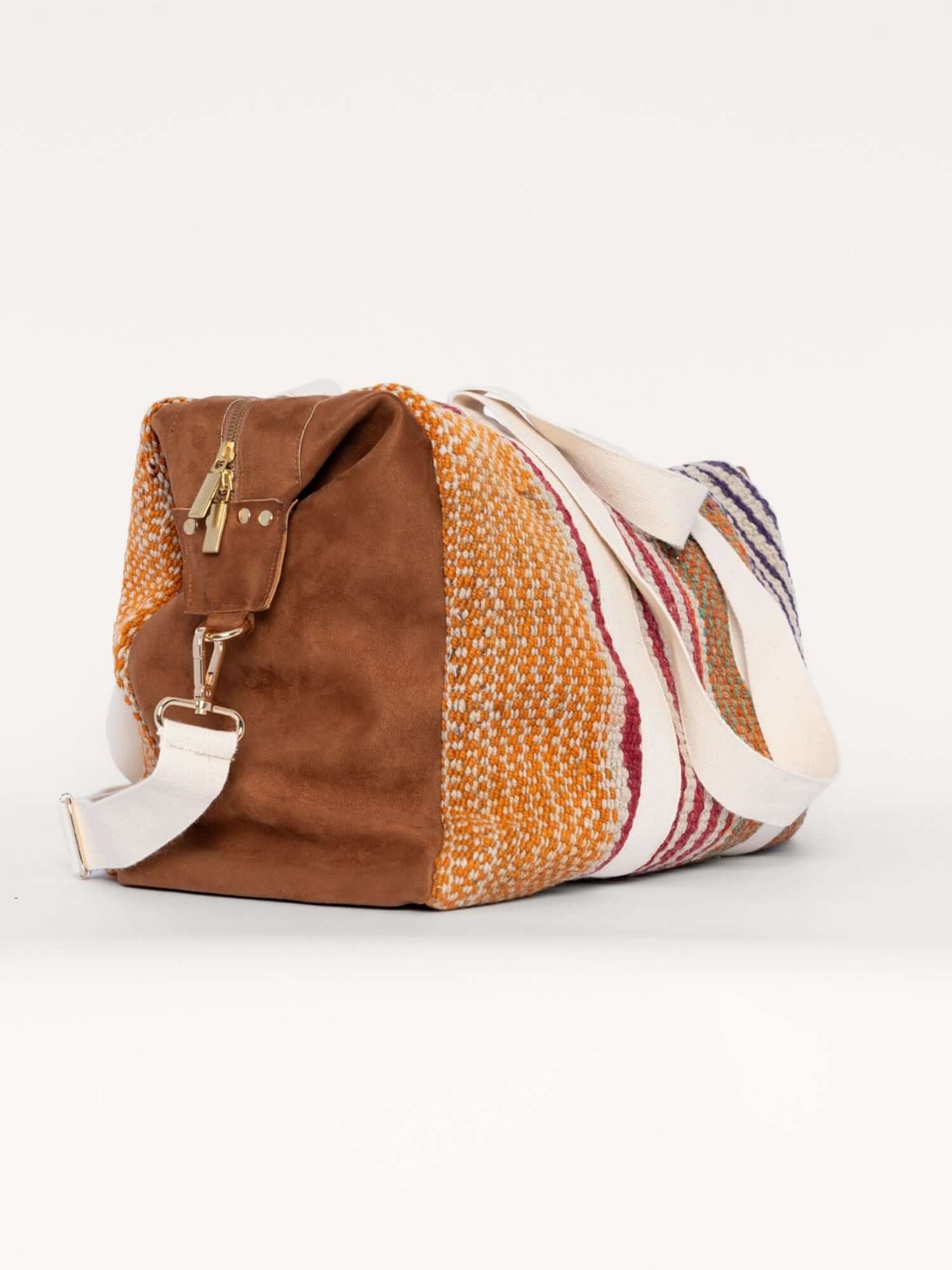 Side view of wool and suede carry-on bag with washed pink and orange tones – versatile and lightweight