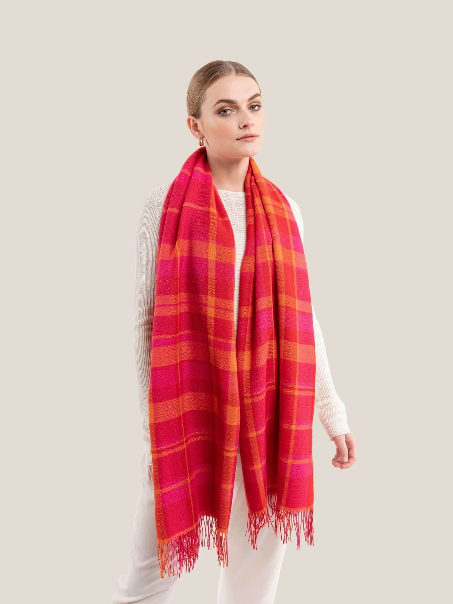 Fuchsia, Red and Yellow alpaca wool shawl draped to show full length and drape, plaid style