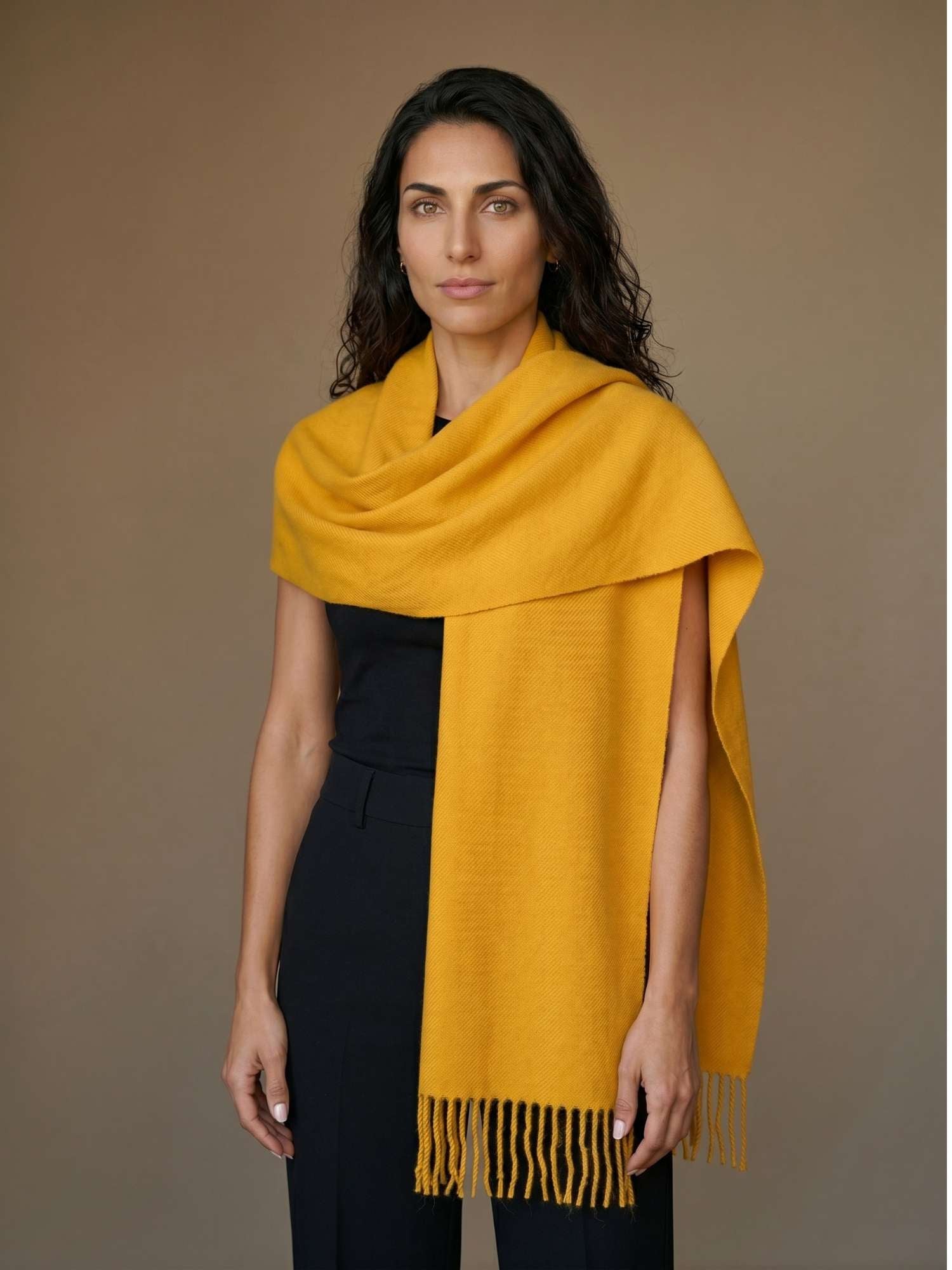 Yellow baby alpaca scarf worn over the shoulders — naturally dyed, softer than cashmere, handmade in Peru | Orange Inca