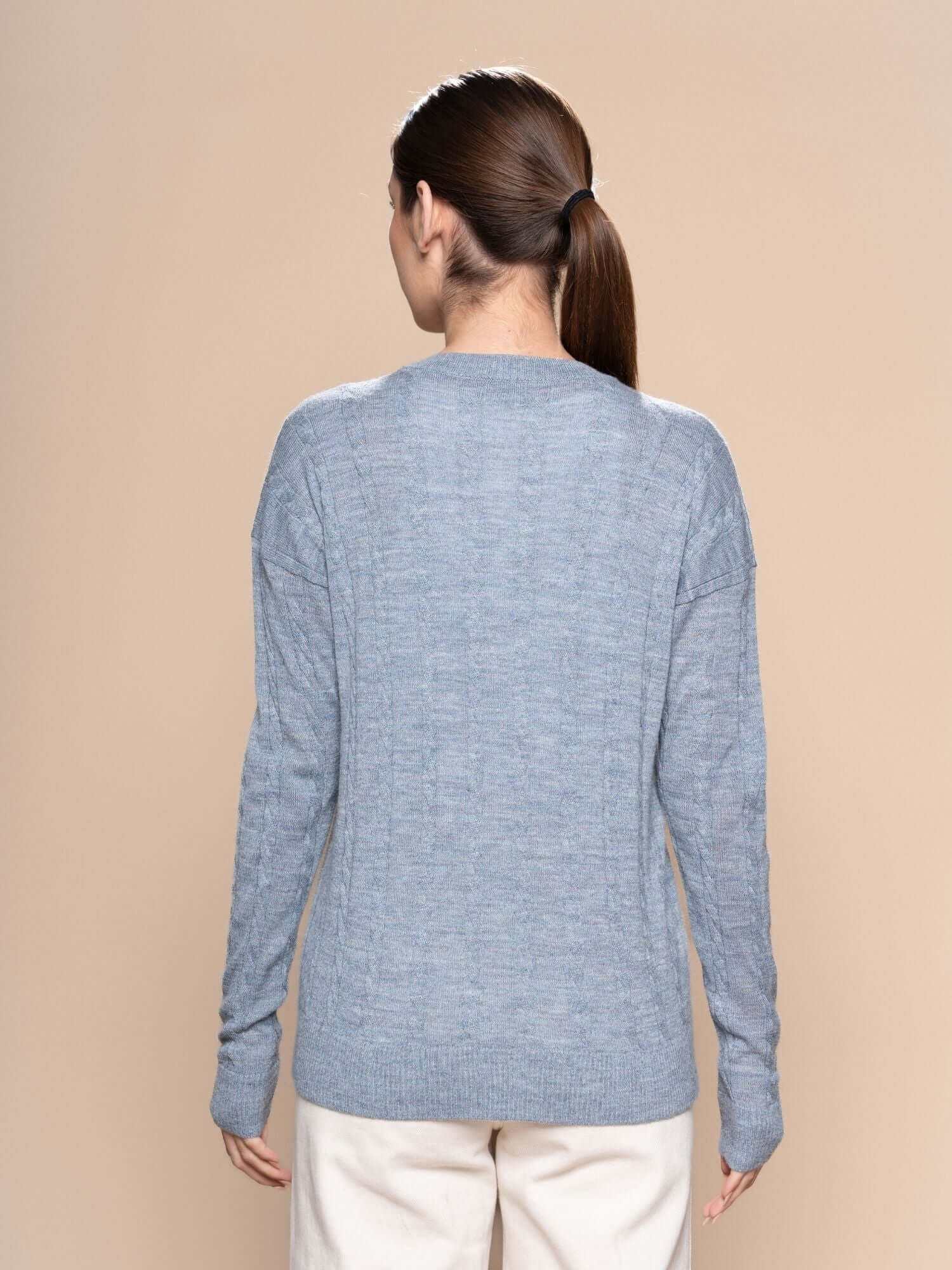 Back view of blue grey braided alpaca wool jumper in soft natural fibres