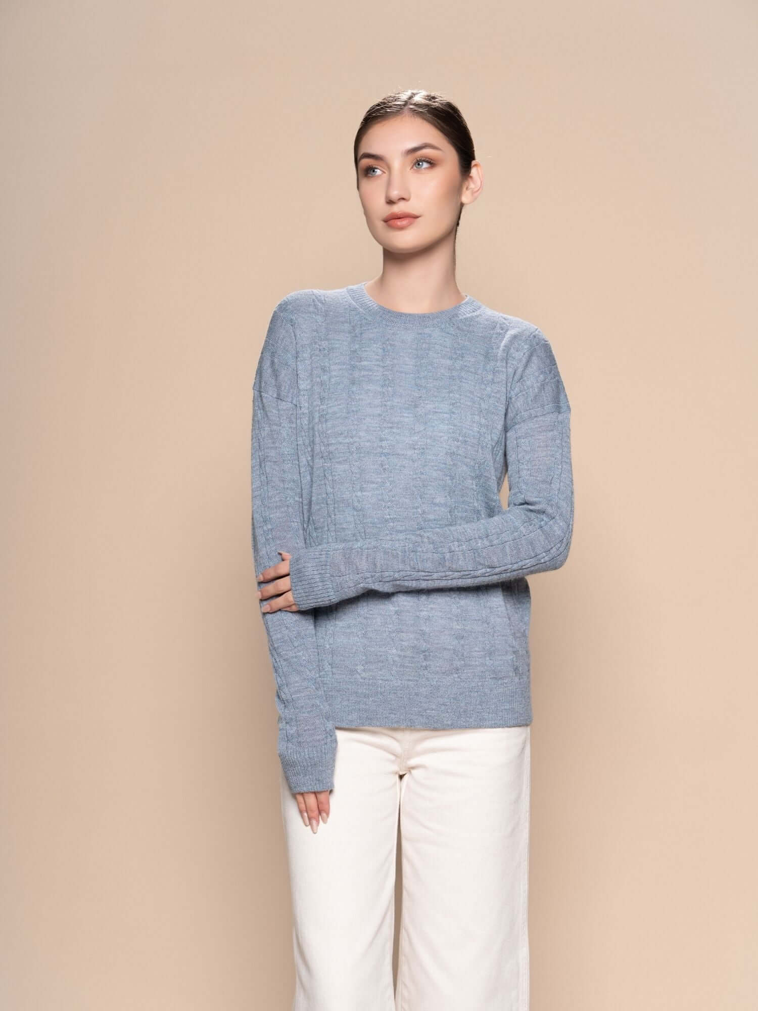 Blue grey braided baby alpaca jumper styled with natural cream trousers