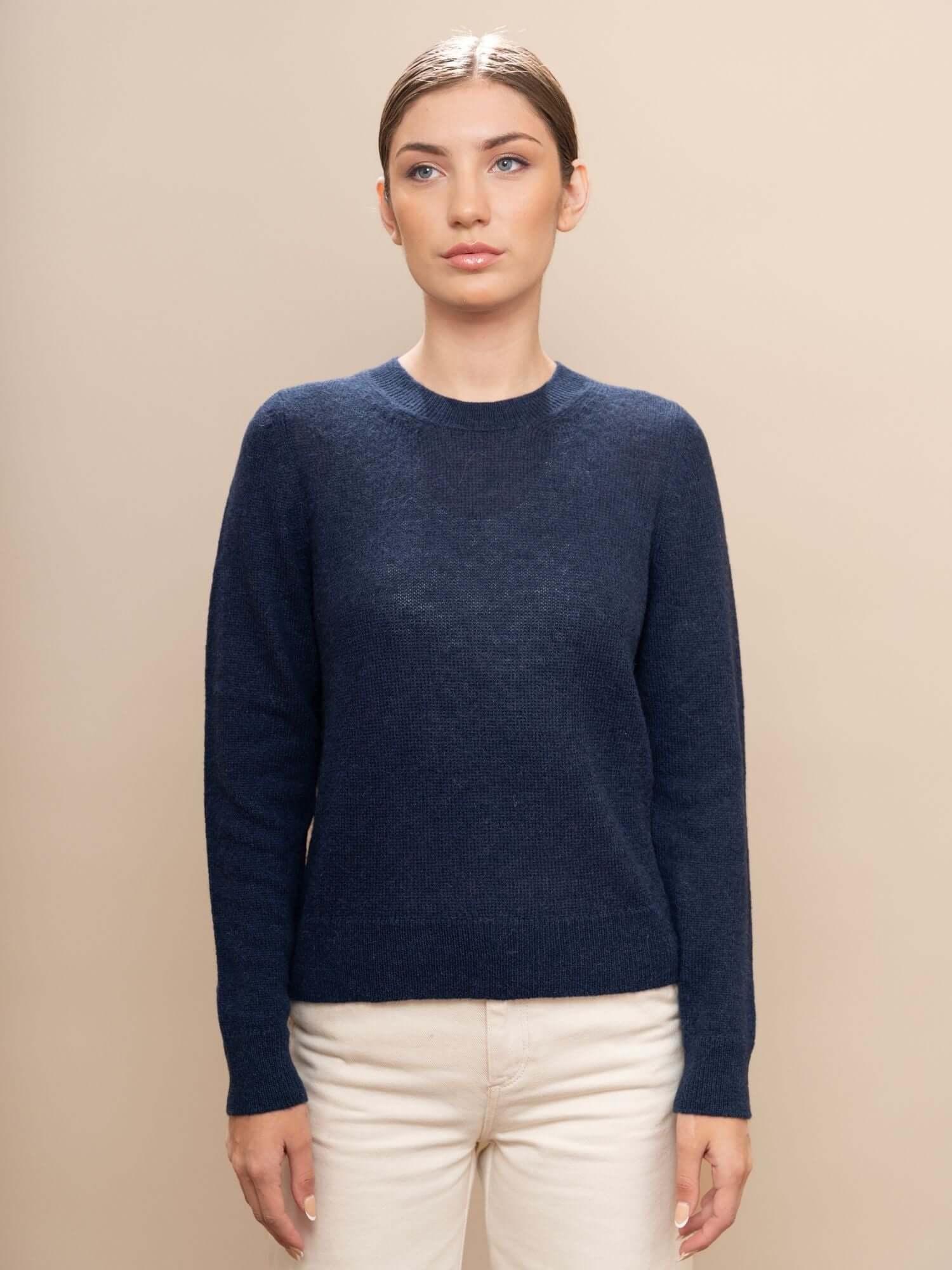 Front view of navy blue classic baby alpaca wool jumper styled on model