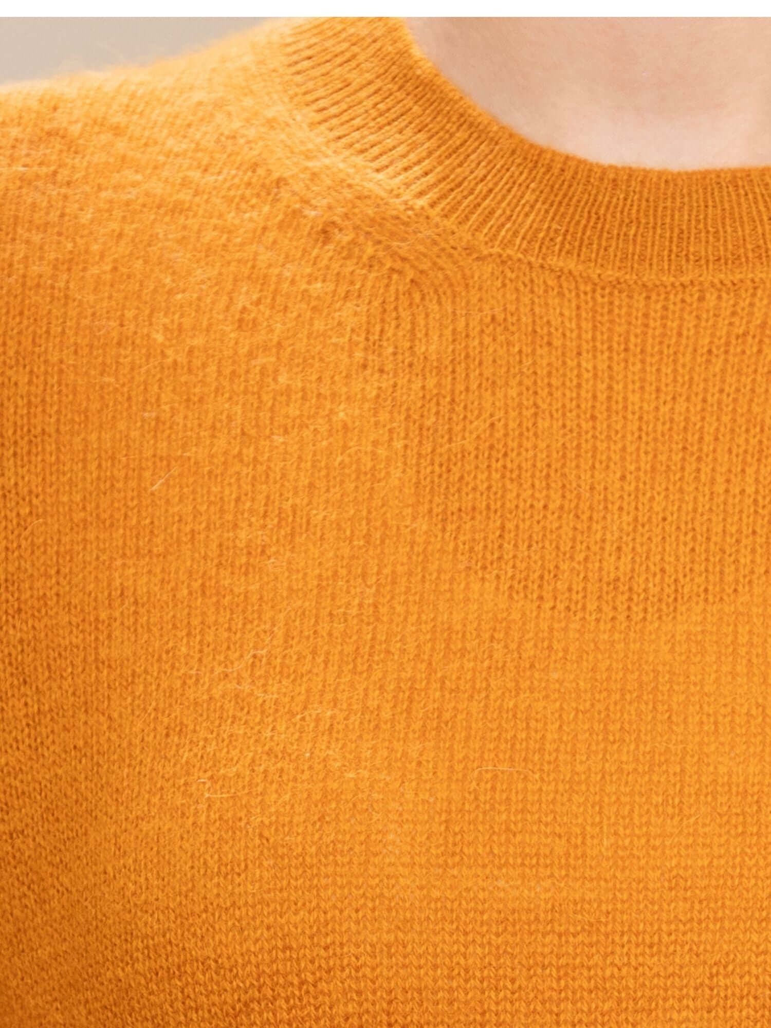 Close-up of neckline and texture on turmeric baby alpaca jumper | Orange Inca