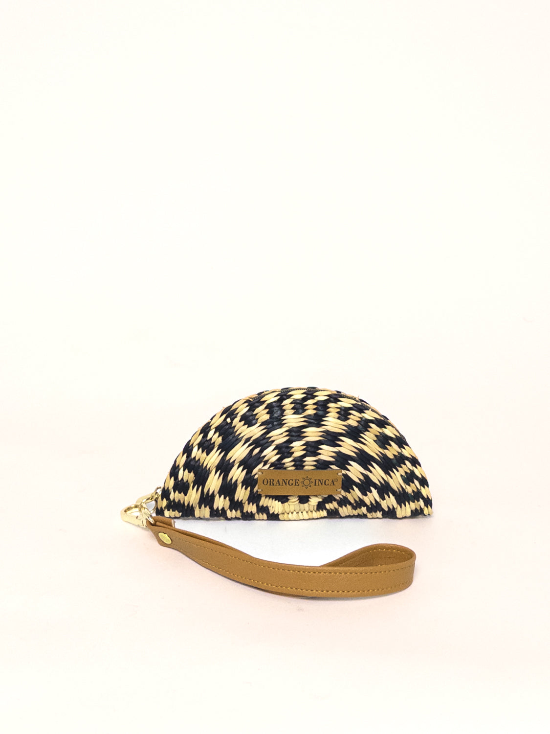 Playa Coin Purse – Faux Leather Strap, handwoven coin purse in navy and cream, junco reed, with a detachable brown faux leather strap.