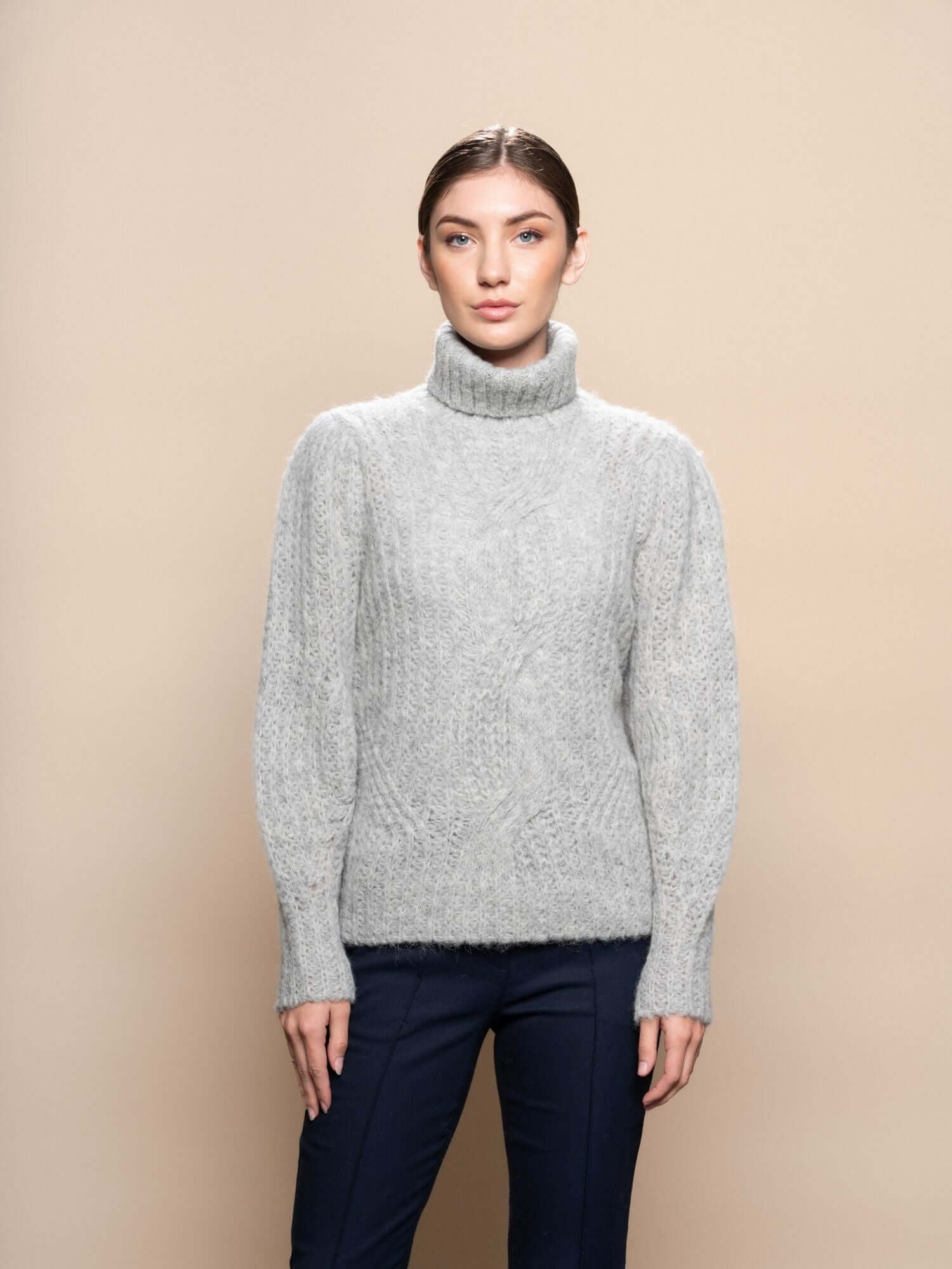Model wearing baby alpaca turtleneck jumper in light grey, soft knit sweater made in Peru