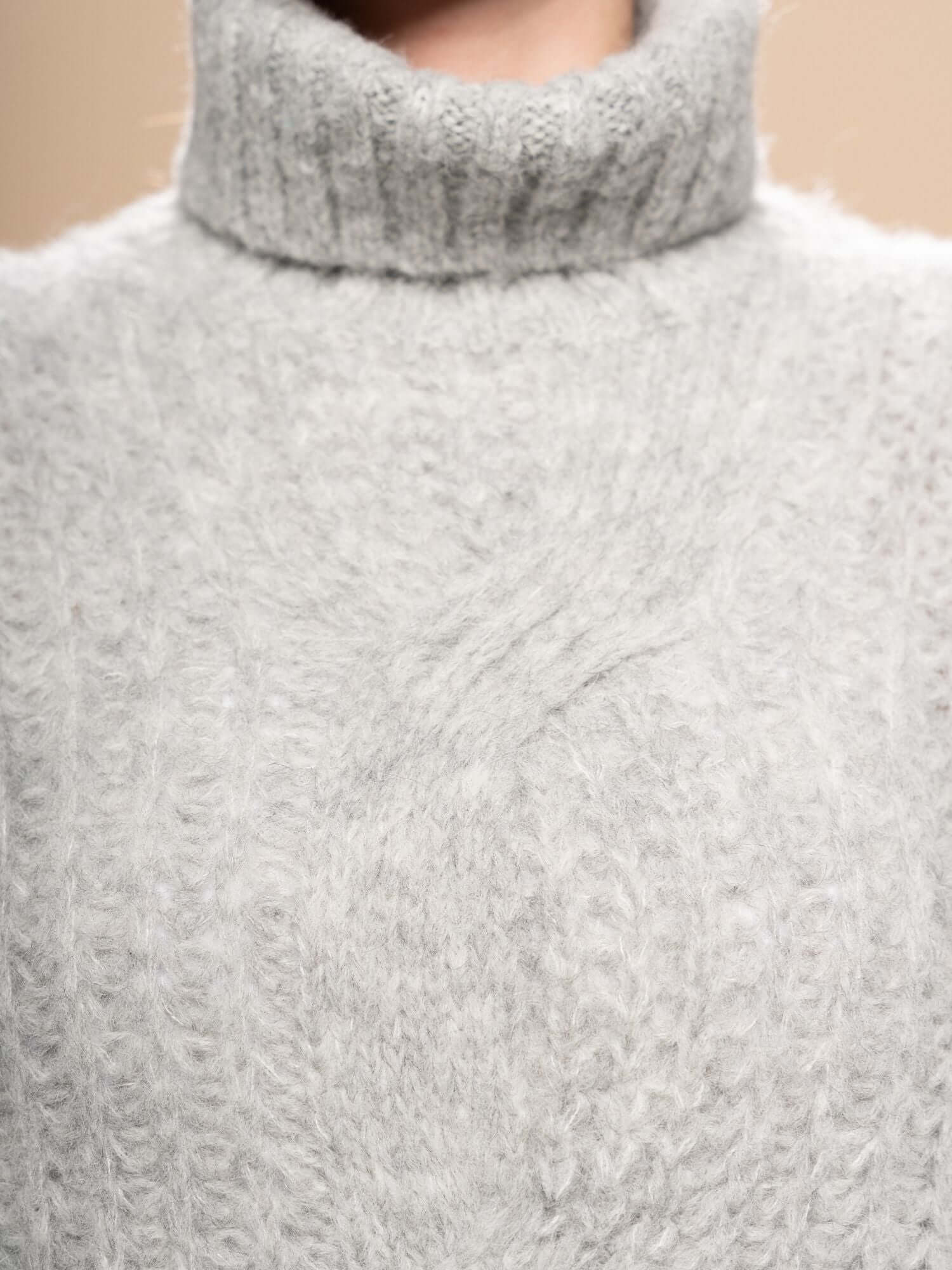 Detail of light grey baby alpaca turtleneck jumper – premium natural knitwear, handmade in Peru | Orange Inca