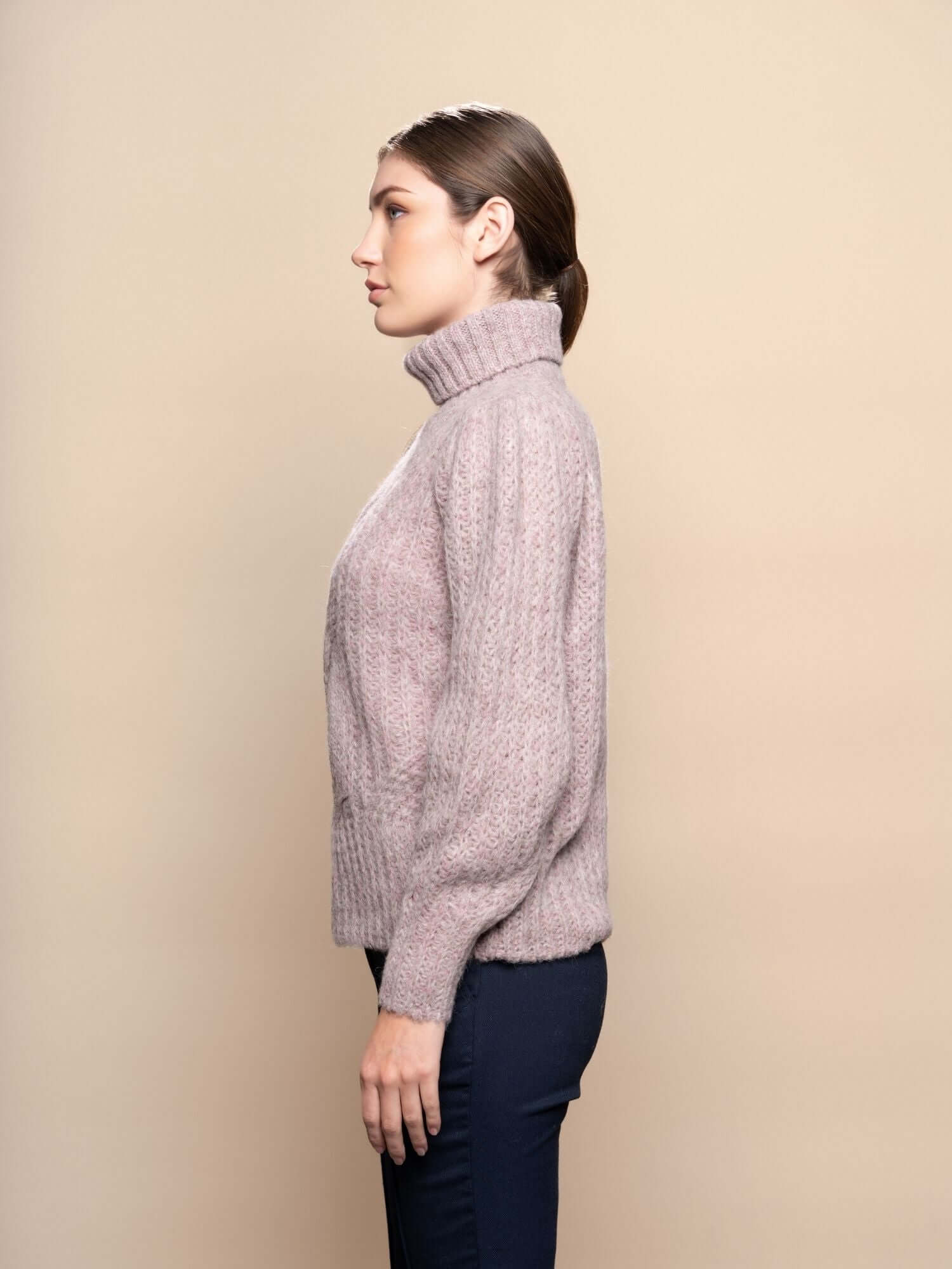 Model wearing pale pink alpaca knit jumper, naturally dyed wool sweater from Peru