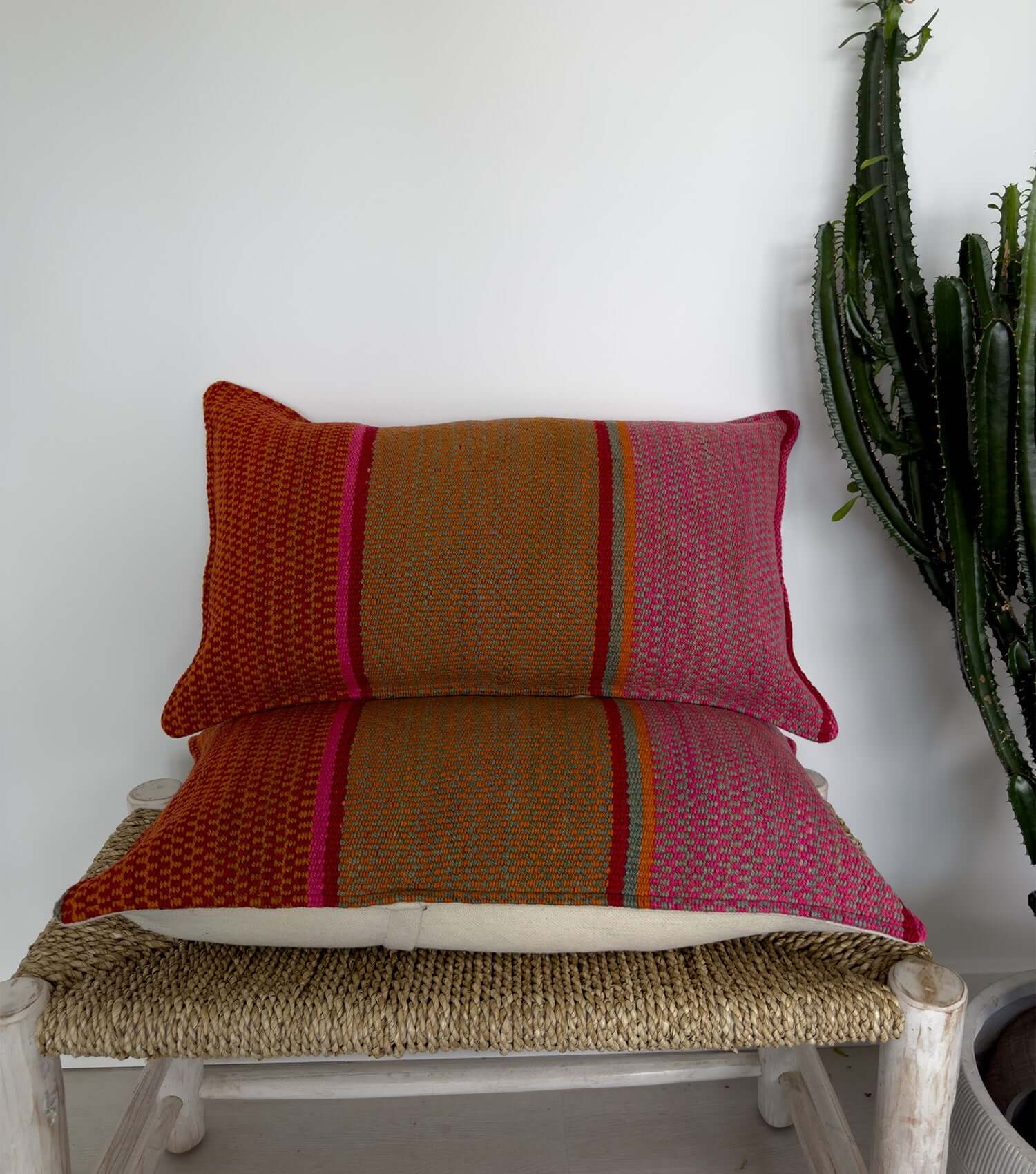 Boho throw pillow, rectangular 70x40 No.10 styled on accent chair or sofa showing living room decor possibilities