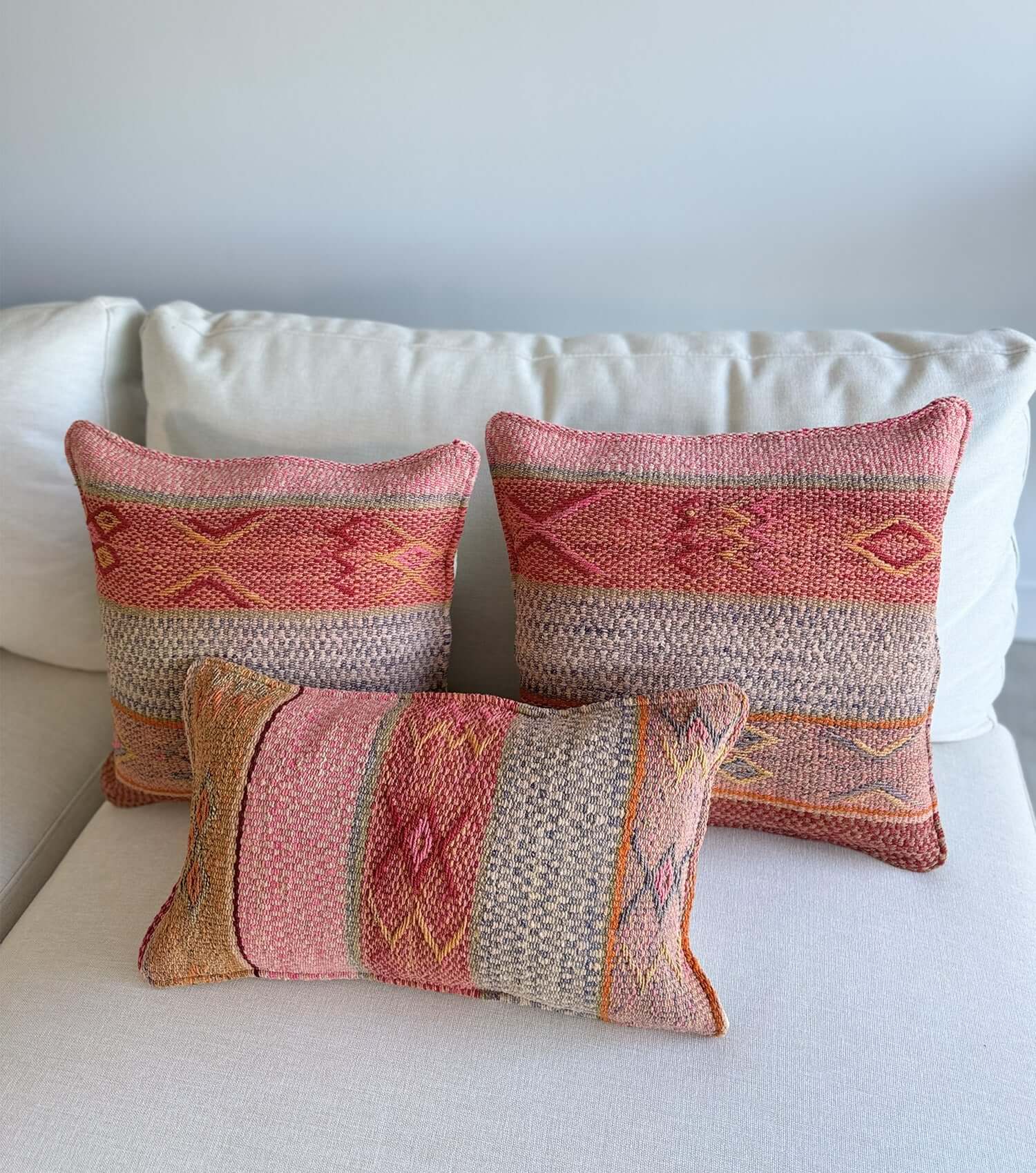 Decorative square pillow No.17 styled on sofa showing ethnic pattern and luxury wool texture