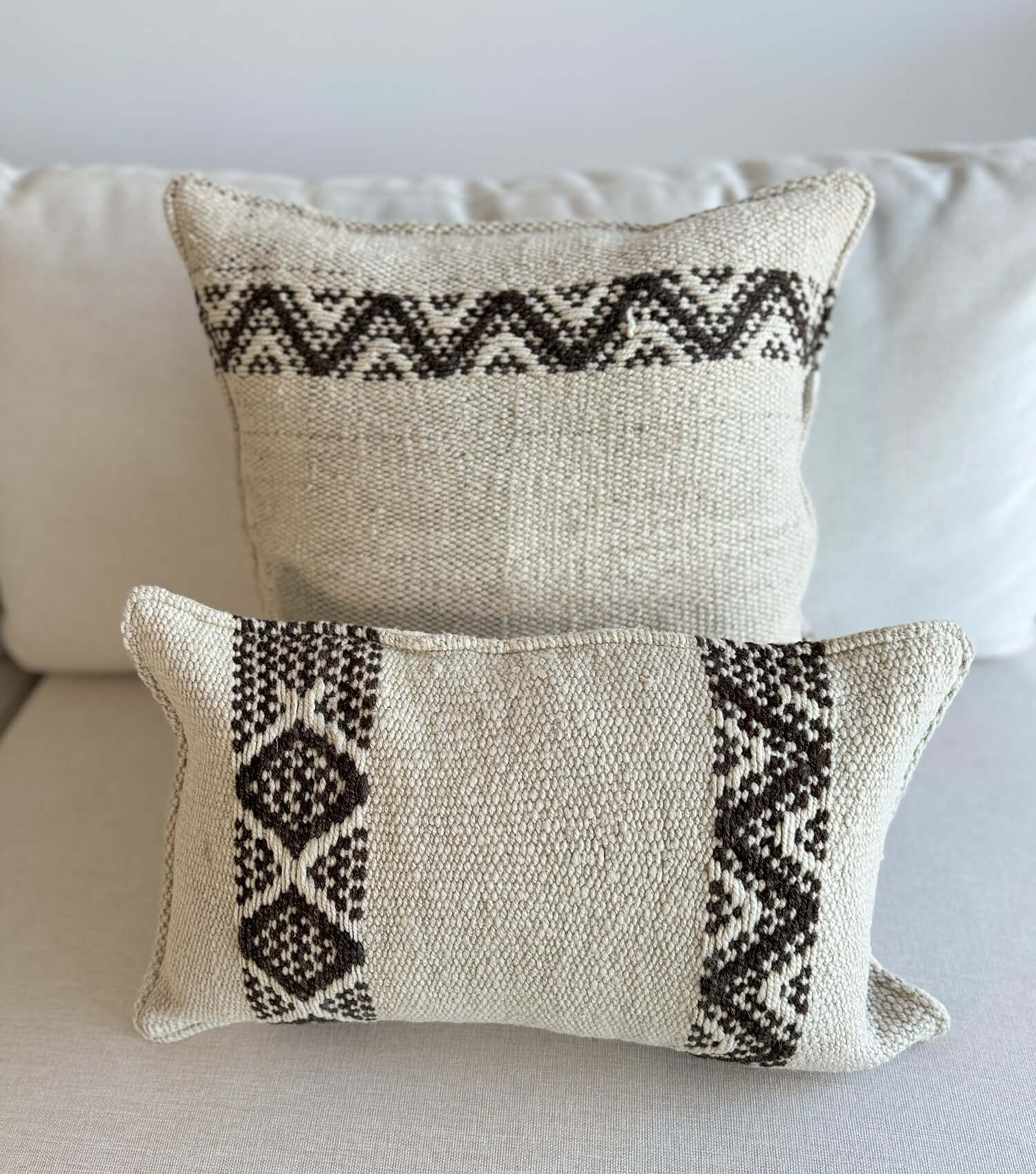 Boho throw pillow 50x30 No.19 styled on accent chair or sofa providing living room decor possibilities, in earthy colours
