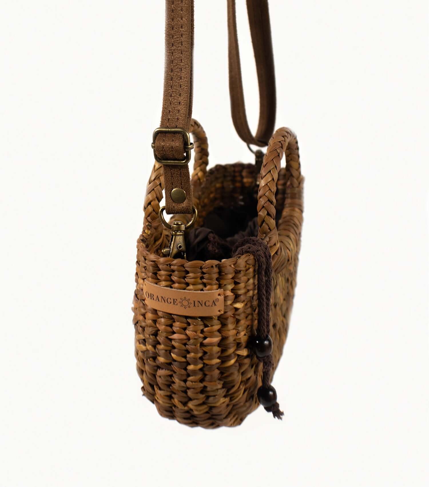 Compact brown straw crossbody bag worn across body – everyday bag handmade in Peru | Orange Inca