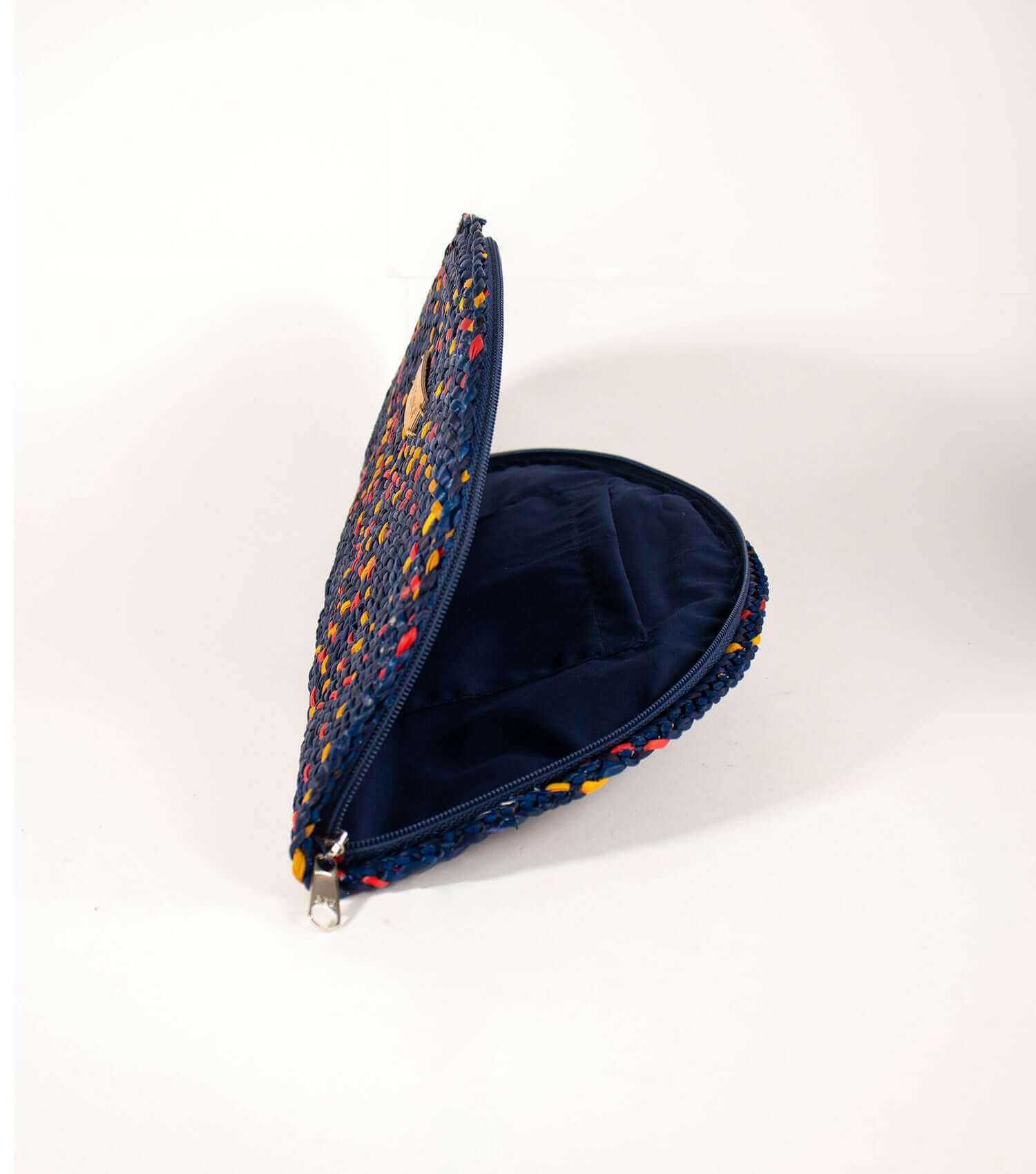 Cocktail purse in blue with red accents with open zipper revealing the elegant lining and convenient inner pocket.