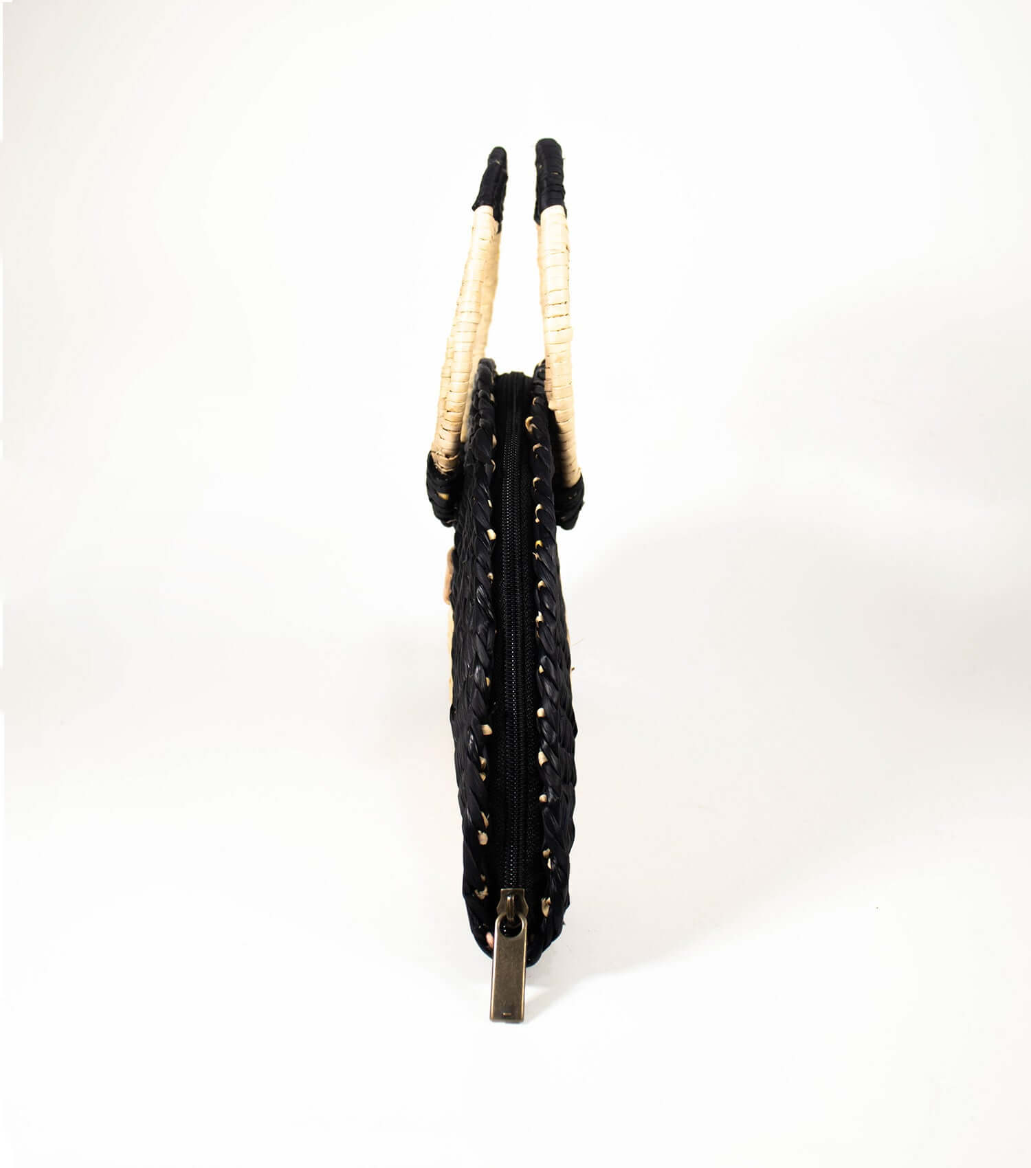 Side view of Flamenco Swing revealing the bag's elegant contours and the quality of the junco weave, blending style with durability.