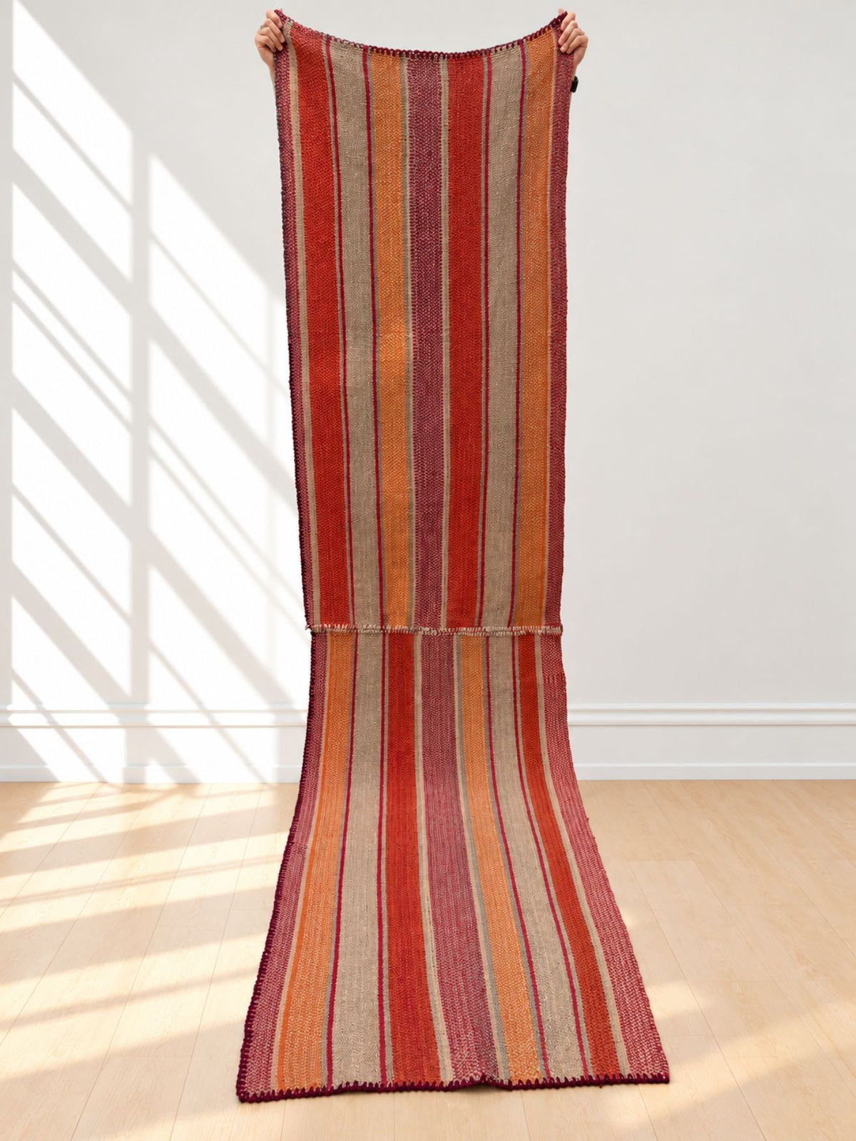 Vintage double frazada runner No. 2 held up in full — red, orange, oat and plum, handwoven Peruvian sheep and alpaca wool, 340 × 82 cm | Orange Inca