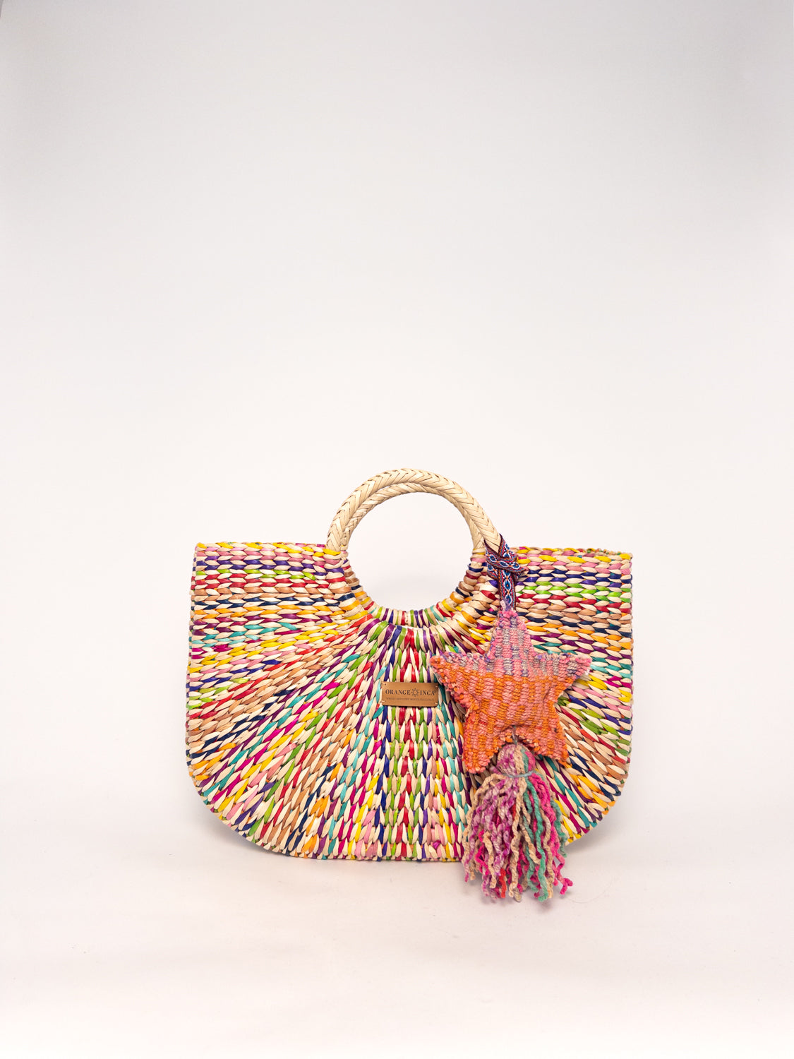 Gran Fiesta Crossbody Tote - Natural Carnival, handwoven junco tote bag, multi-colored with round handles and star tassel.