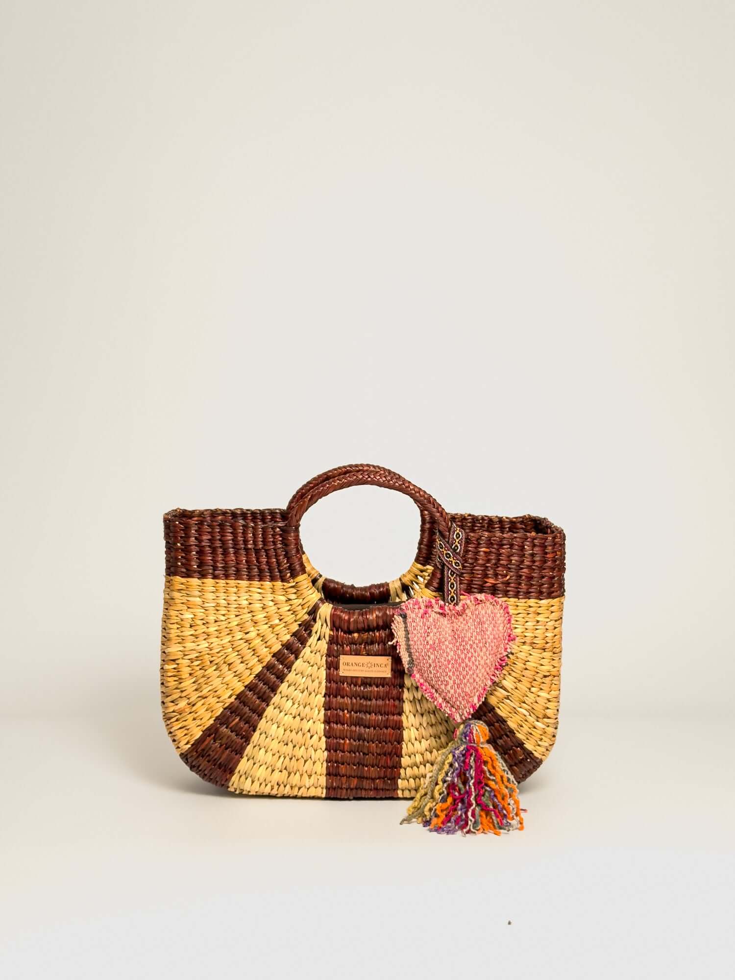 Gran Fiesta Crossbody Tote - Natural and Browns, handwoven junco tote bag with structured handles and tassel.