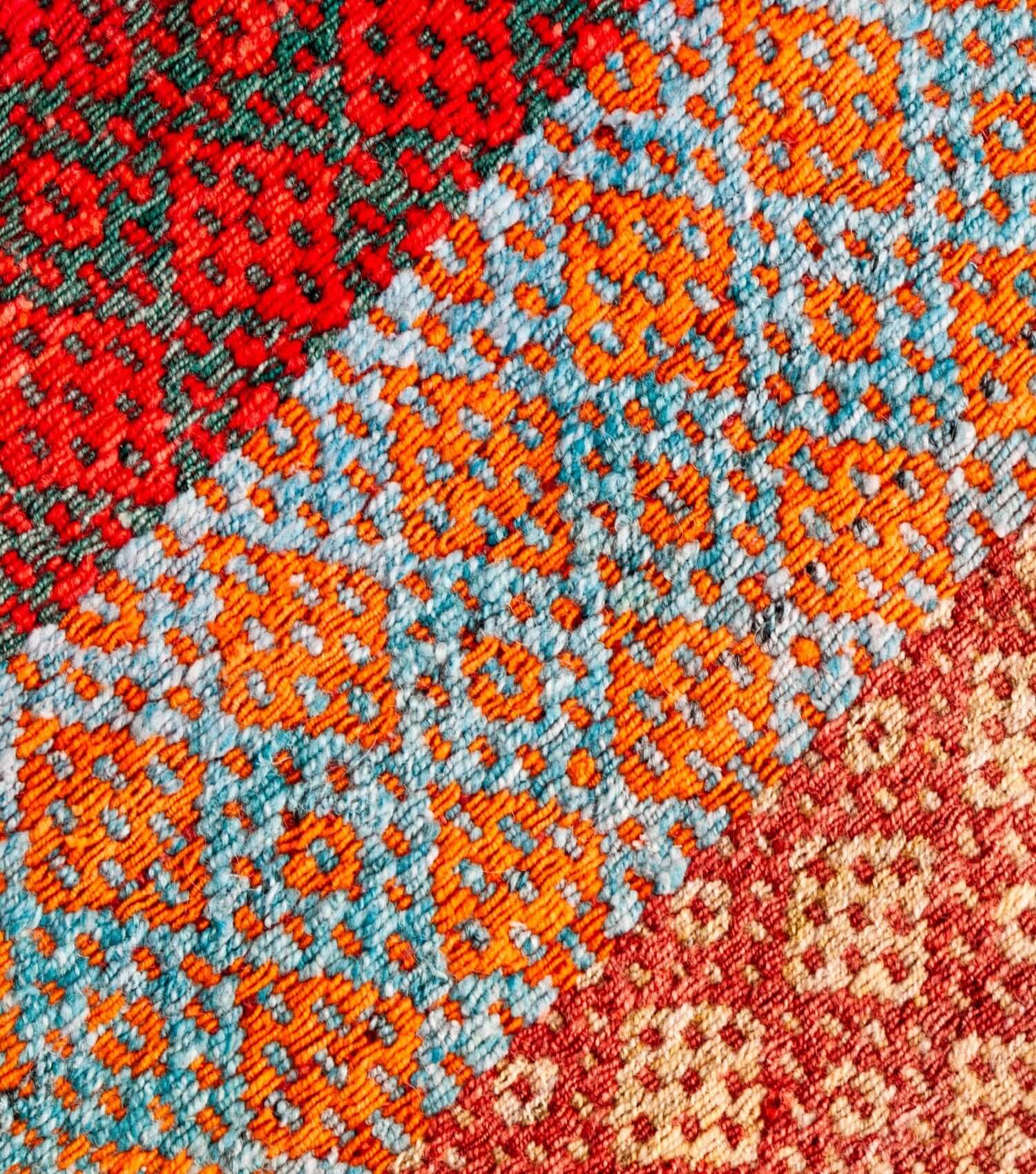 Close-up of traditional Peruvian weaving technique showing intricate washed pink, blue, turquoise and lilac pattern detail - frazada no 17