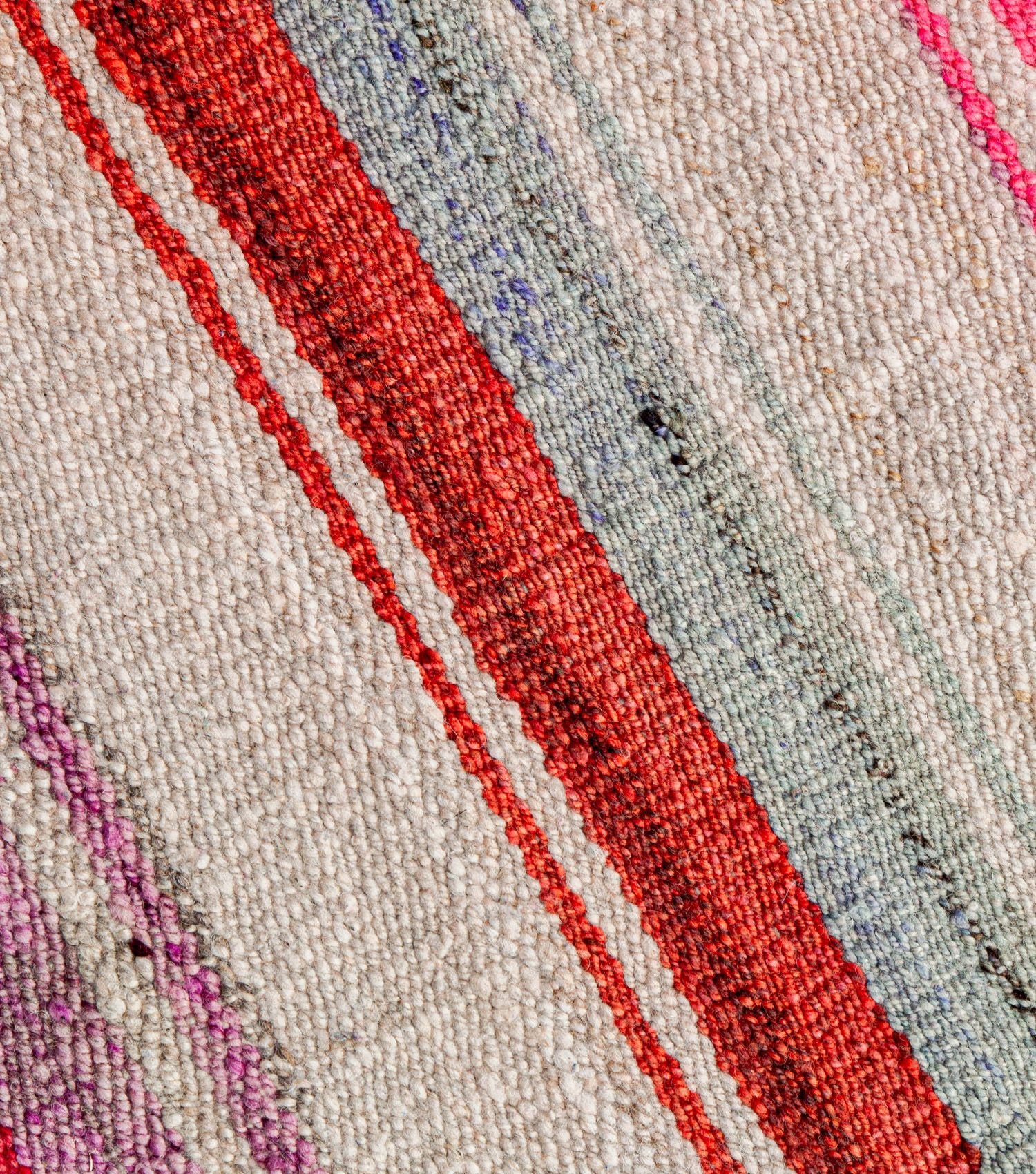 Close-up of traditional Peruvian weaving technique showing intricate washed pink, orange and earthy colours pattern detail - frazada no 2