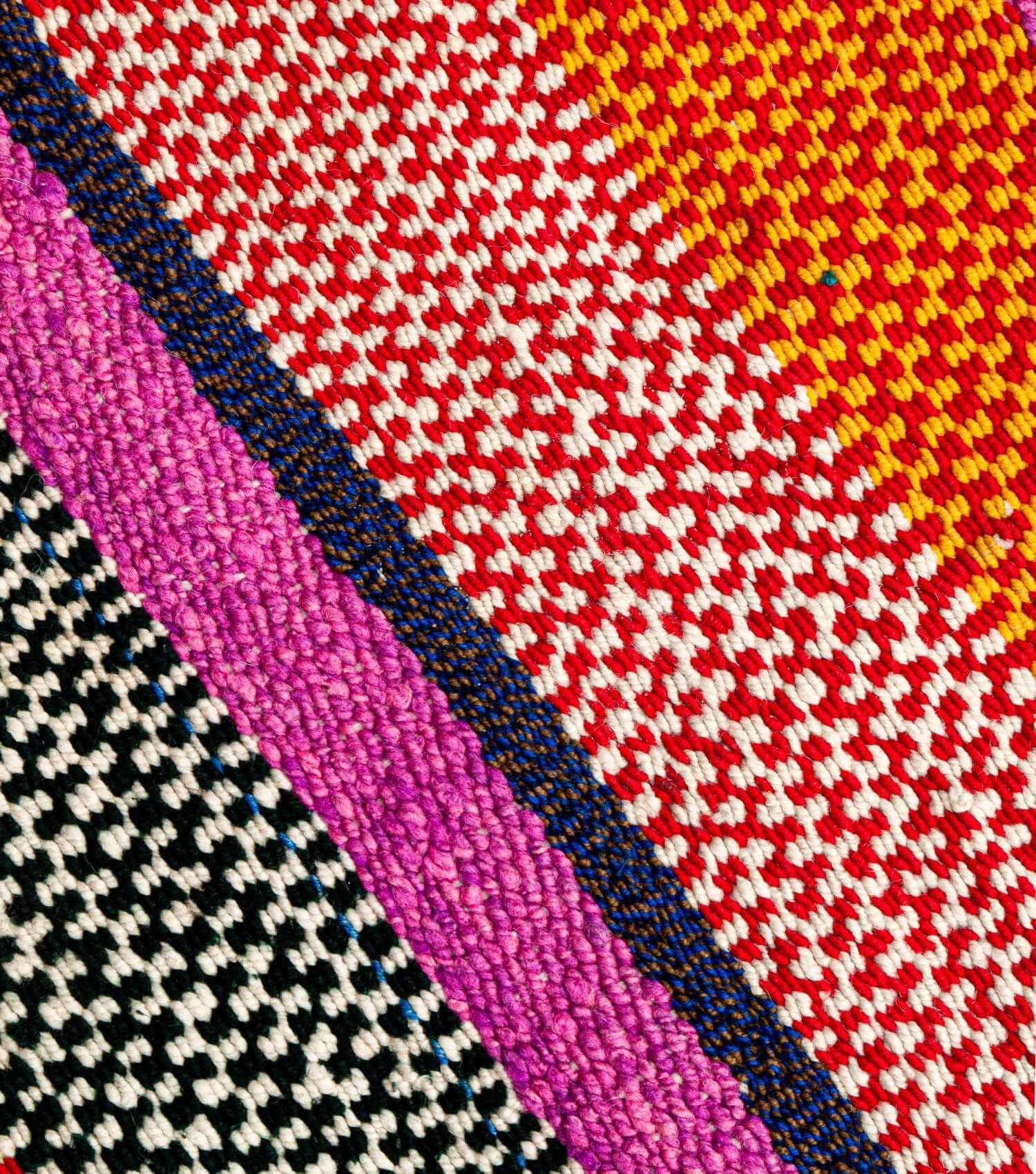 Close-up of traditional Peruvian weaving technique showing intricate washed orange, yellow, brown and pink pattern detail - frazada no 6