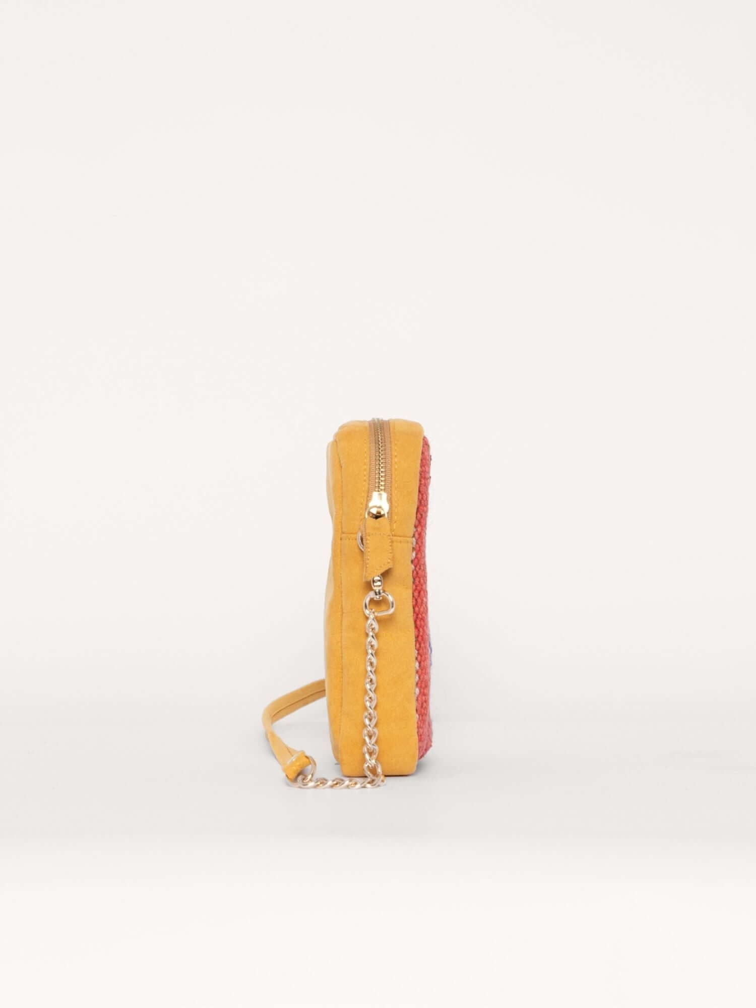 Side view of compact phone bag with yellow suede frame and vibrant orange-blue wool panel