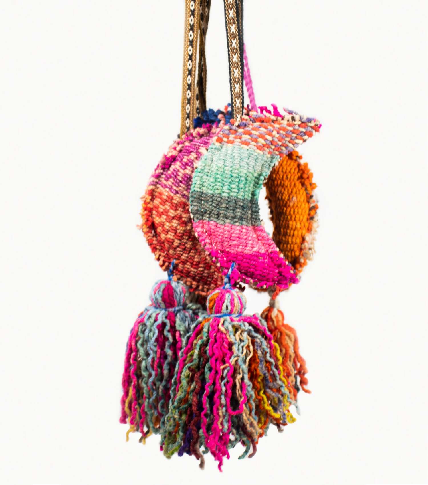 Large half-moon wool tassel draped over door handle as home decor | Orange Inca
