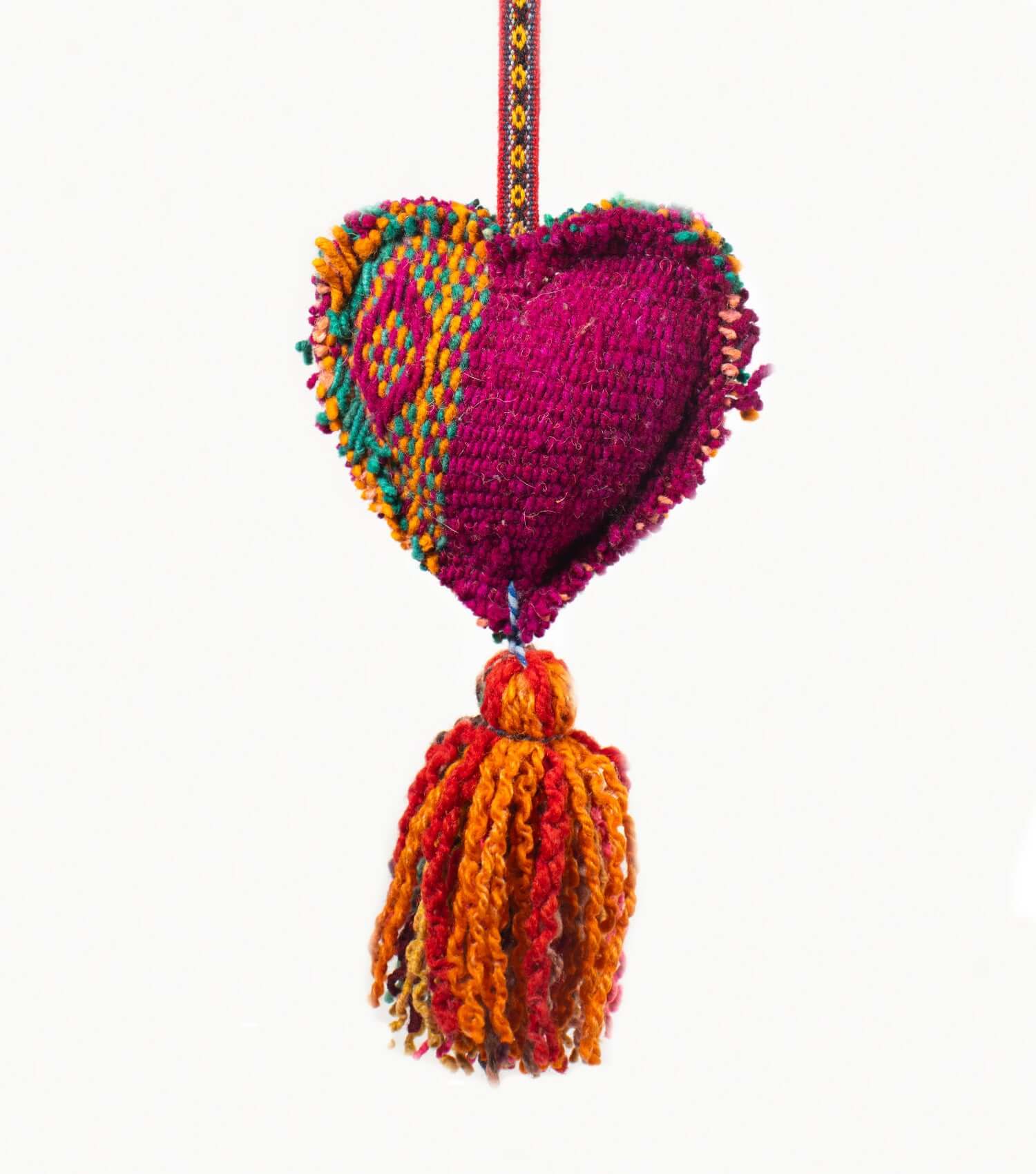 Close-up of handmade wool heart tassel showing premium frazada textile and natural dyes