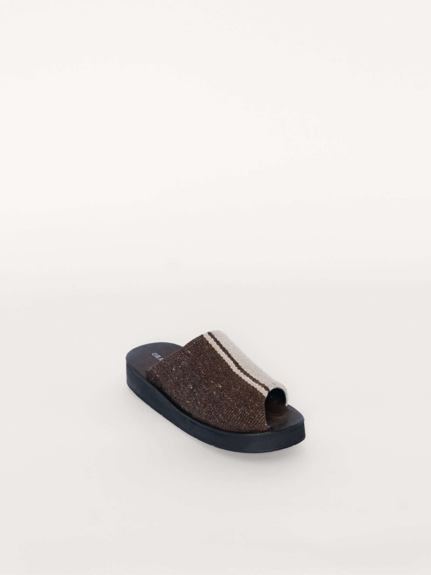 Artisan-crafted wool and suede clogs in earthy tones, front diagonal view.