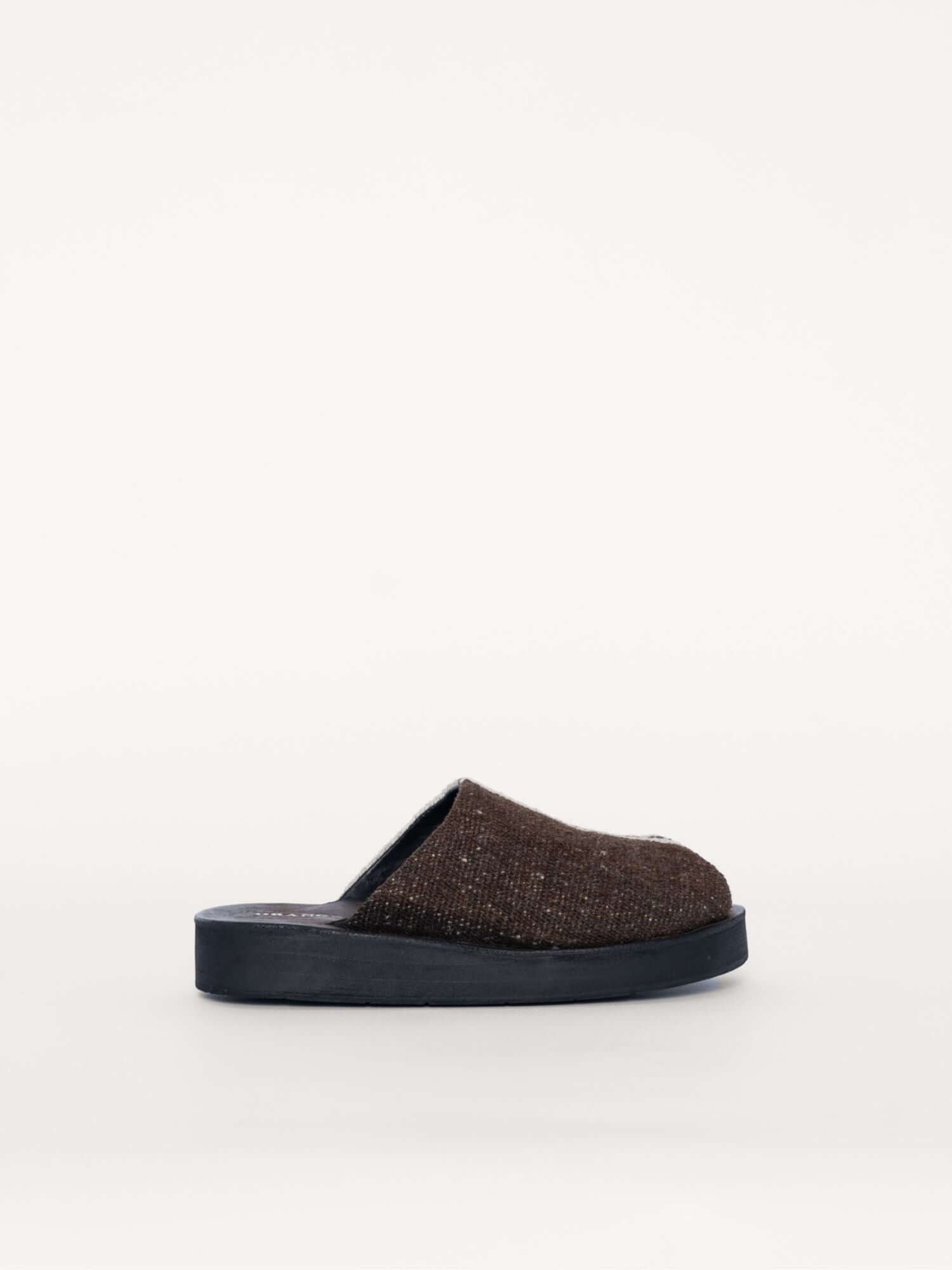 Brown and ivory suede clogs with toe opening and handwoven wool accents, side view.