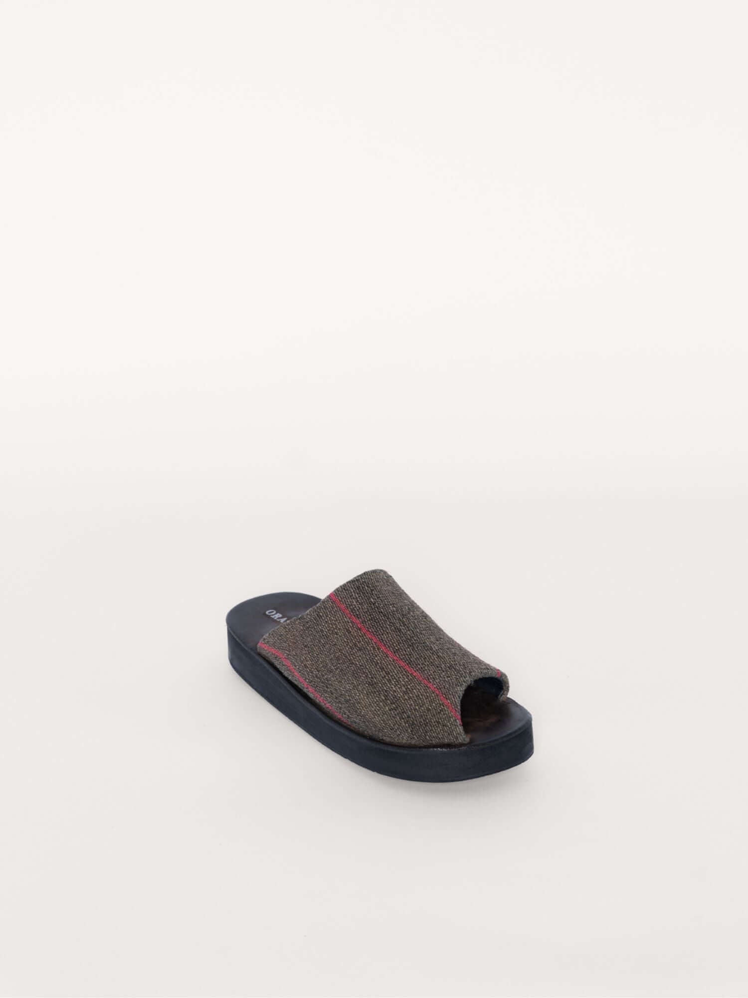 Eco-conscious wool and leather clogs with bold accents, diagonal front.
