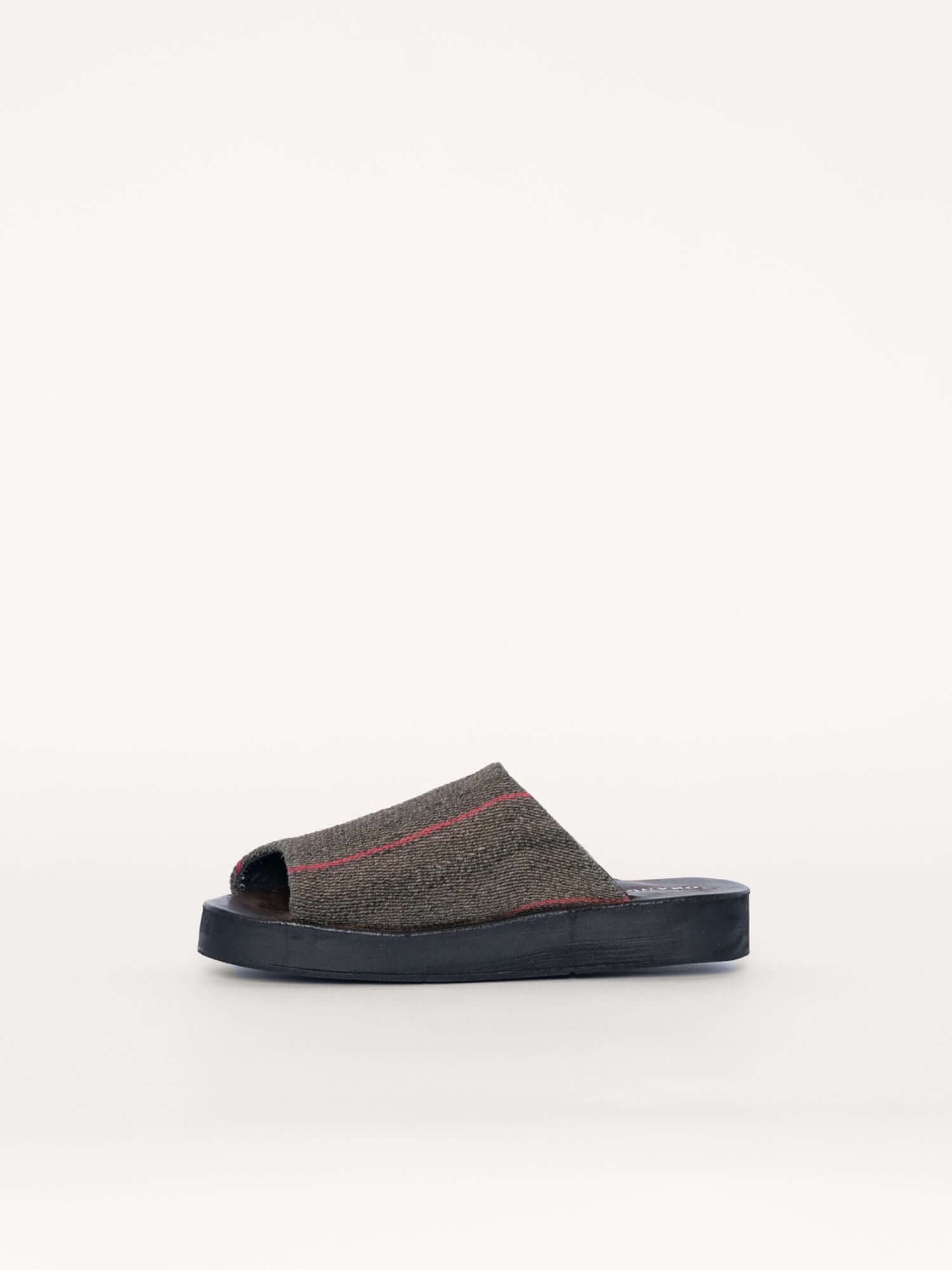 Handwoven wool and suede clogs in green, gray, and fuchsia, left side.