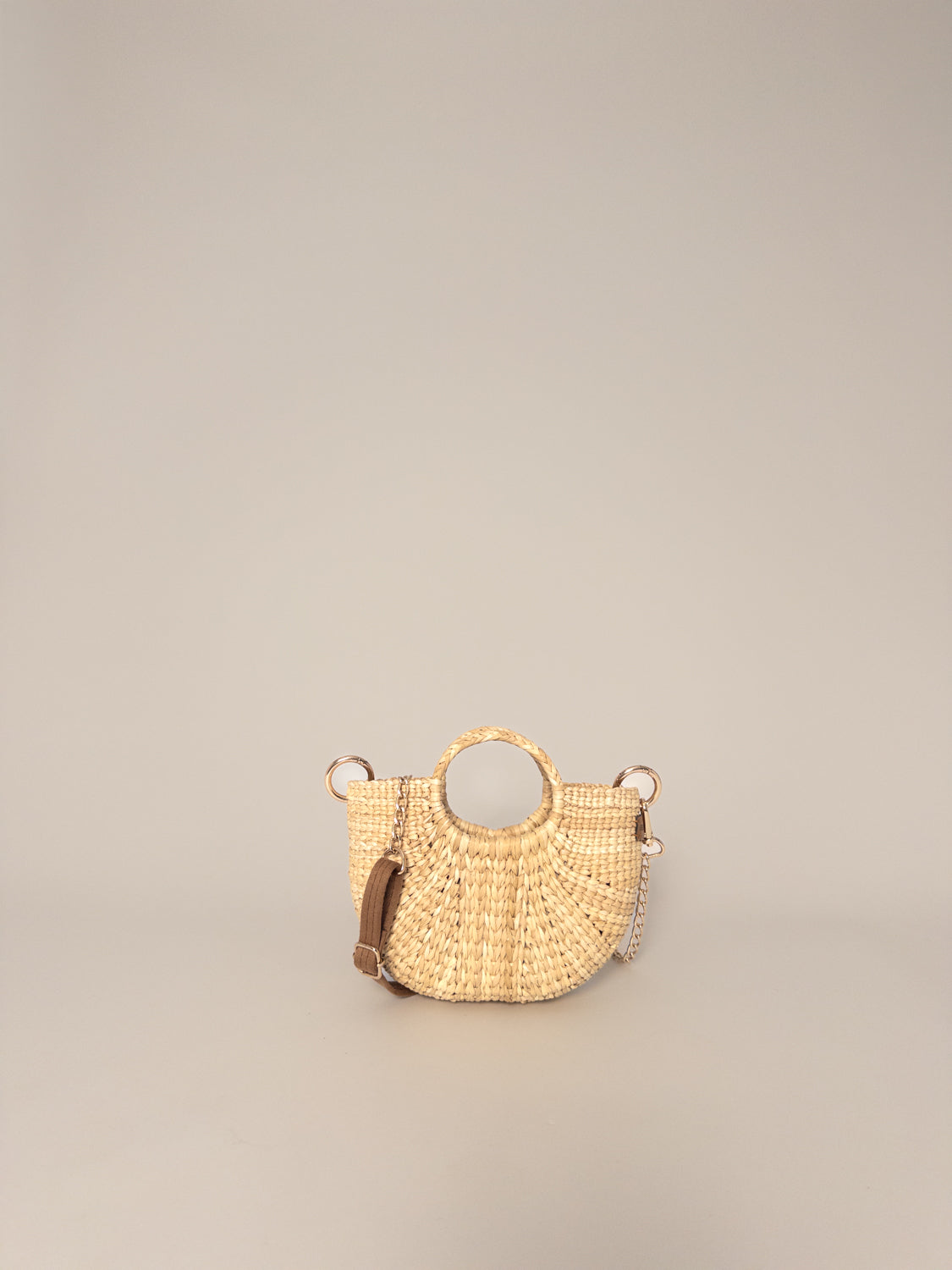 The Fiesta Mini Deluxe - Natural handwoven junco crossbody bag, round handle, natural colour, artisanal craftsmanship.