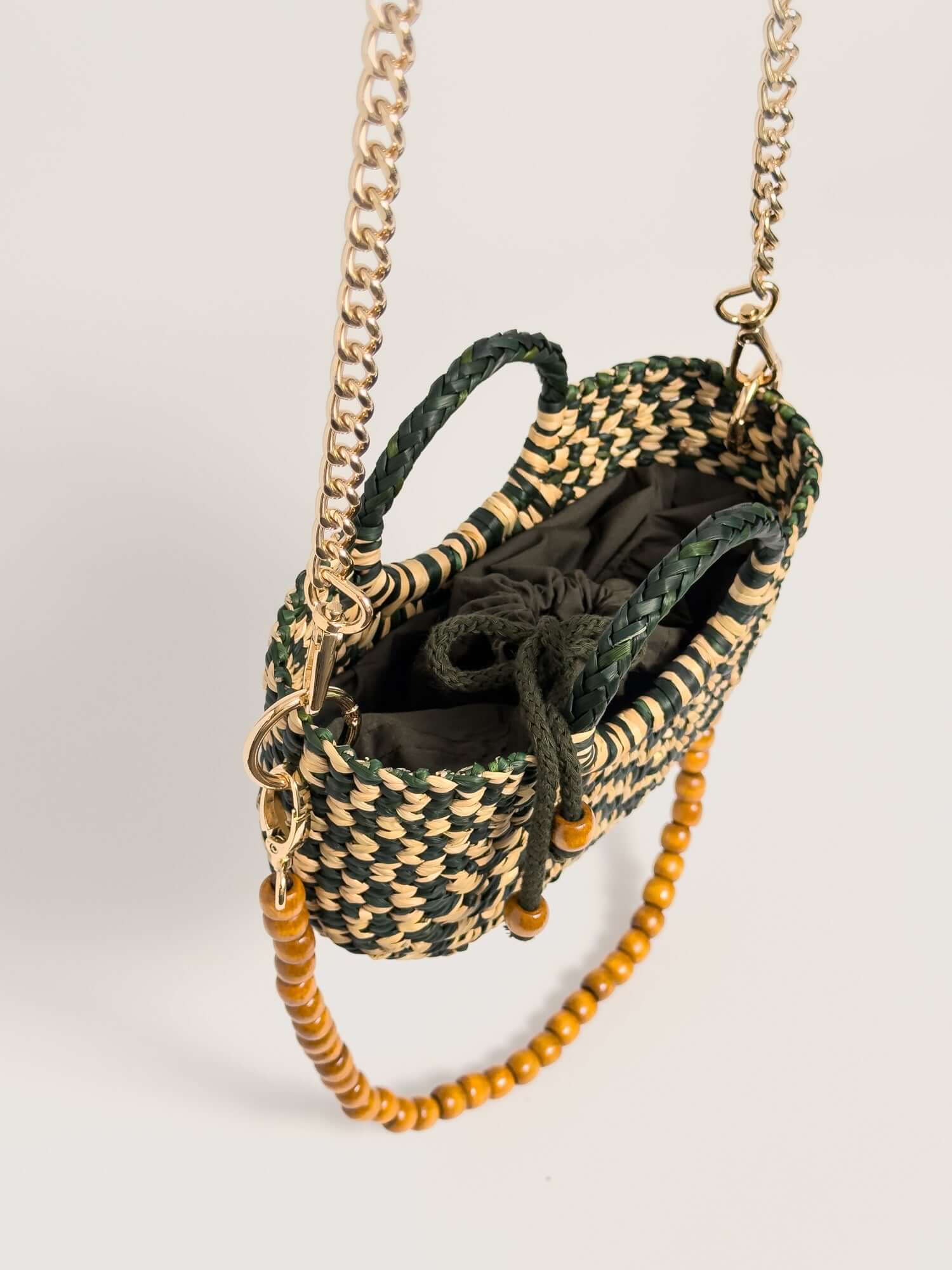 The Fiesta Mini Deluxe - Checkered Olive Green and Natural handwoven junco crossbody bag with chain and wooden bead straps.