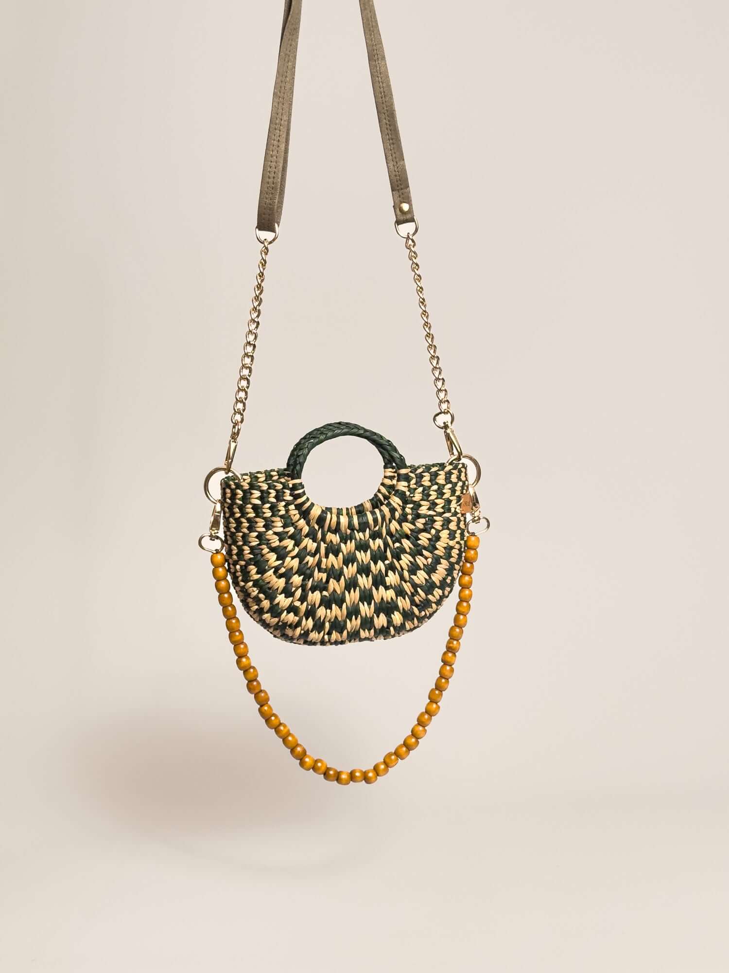 The Fiesta Mini Deluxe - Checkered Olive Green and Natural handwoven junco crossbody bag with beaded strap and chain.