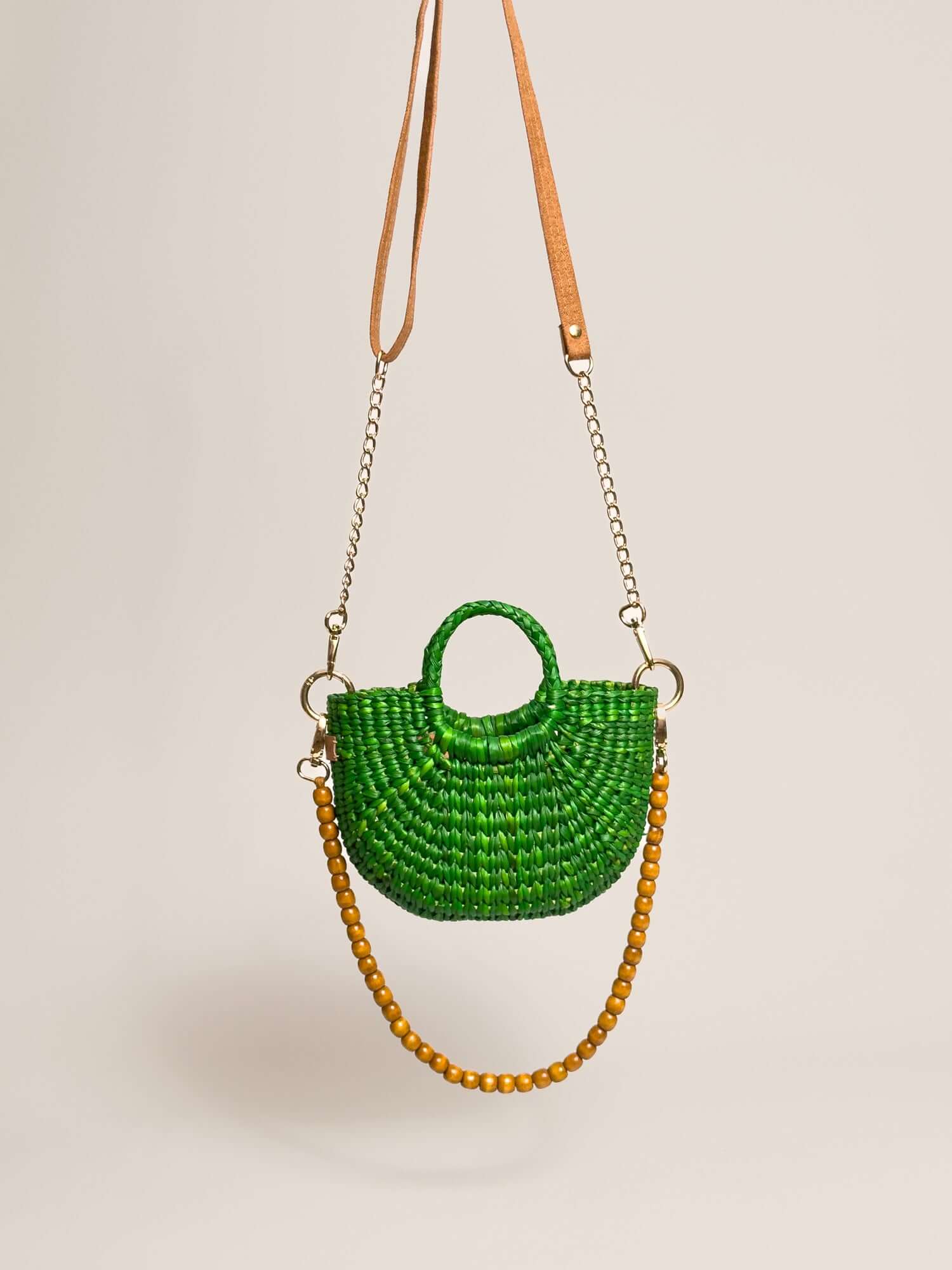 The Fiesta Mini Deluxe - Emerald Green handwoven junco crossbody bag with natural fibre handbag features, chain and wooden bead straps.