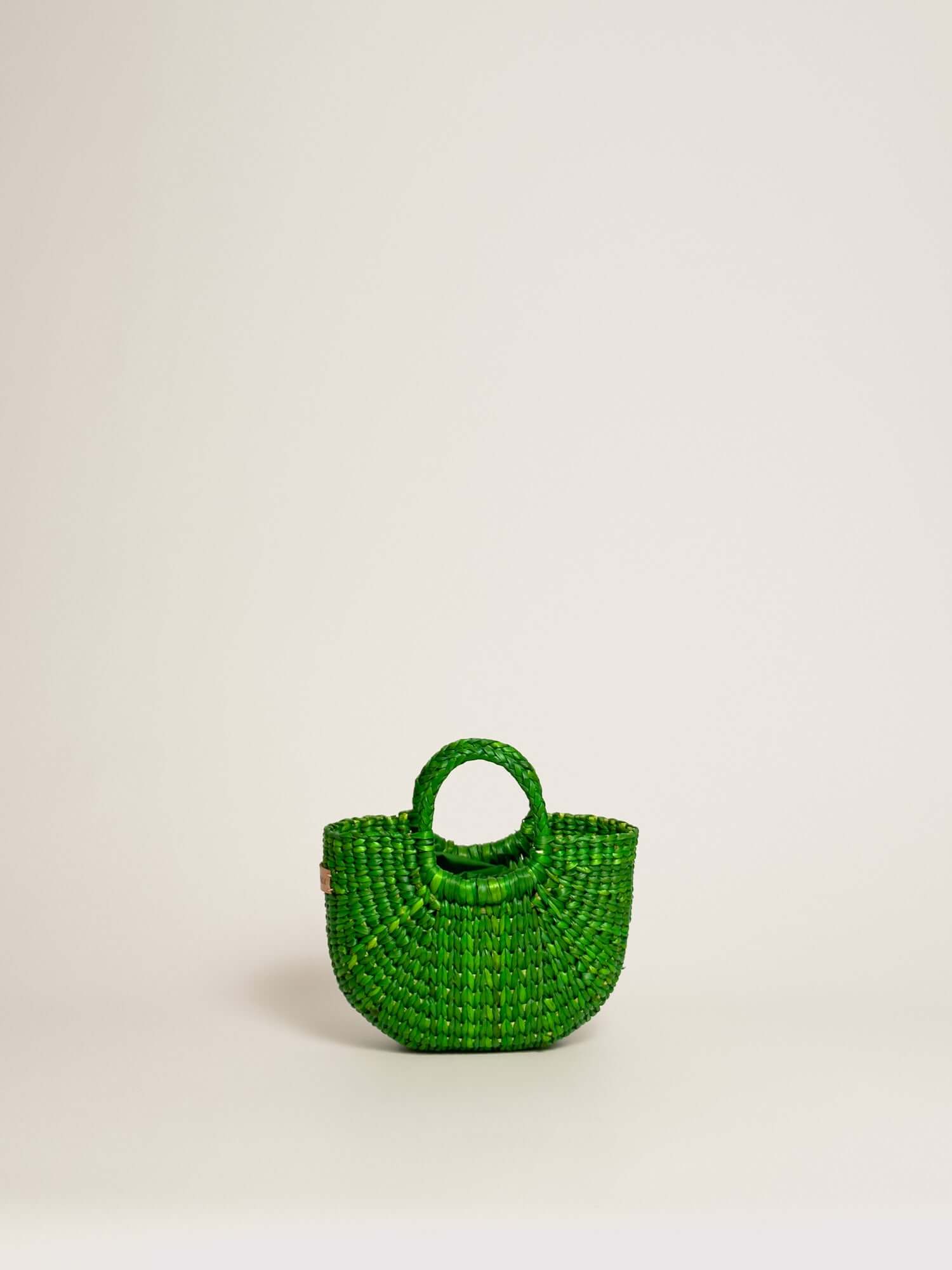 The Fiesta Mini Deluxe - Emerald Green, handwoven junco crossbody bag, natural fibre handbag, green, round handles.