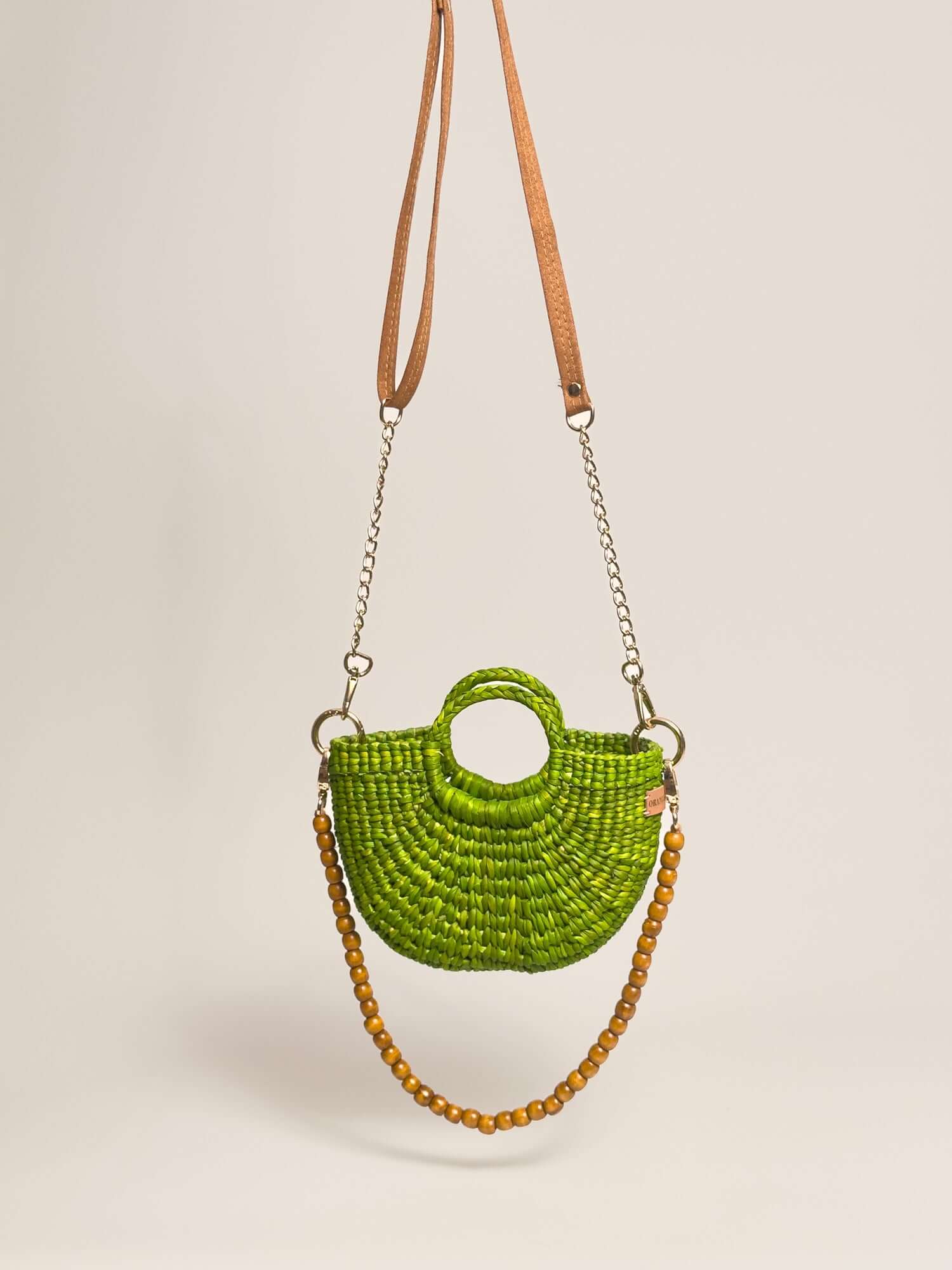 The Fiesta Mini Deluxe - Lime Green handwoven junco crossbody bag with leather and wooden bead straps.