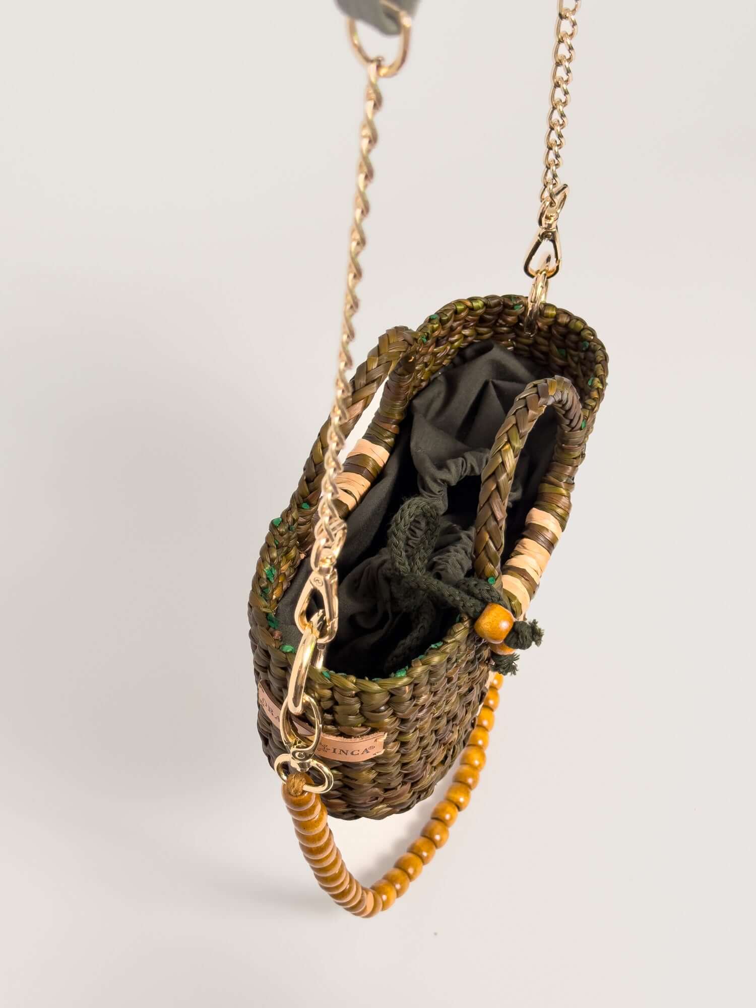 The Fiesta Mini Deluxe - Olive Green with Natural Band, handwoven junco crossbody bag, chain and wooden bead strap, open view.