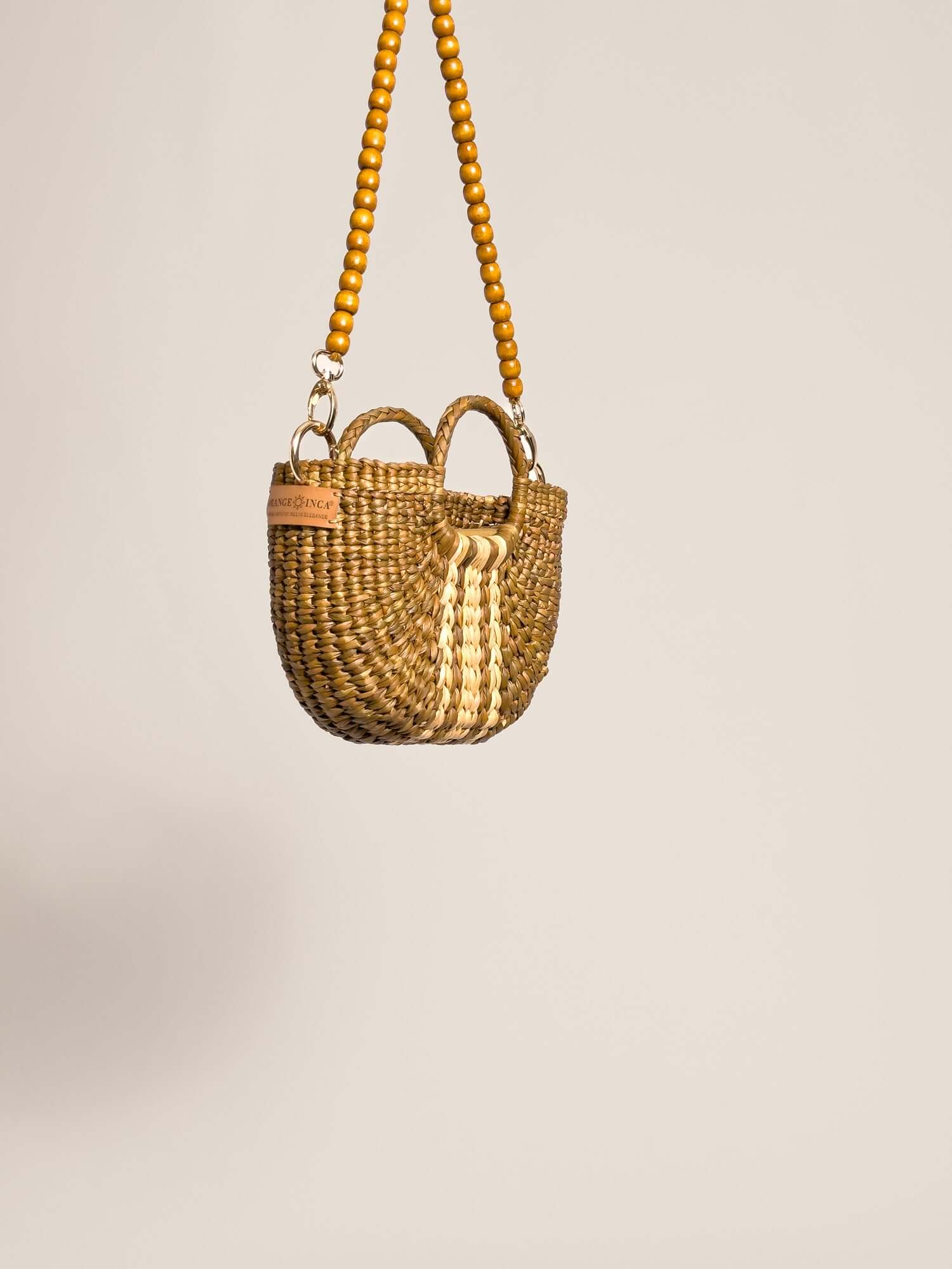 The Fiesta Mini Deluxe - Sage with Natural Band handwoven junco crossbody bag with wooden bead strap and twin handles.