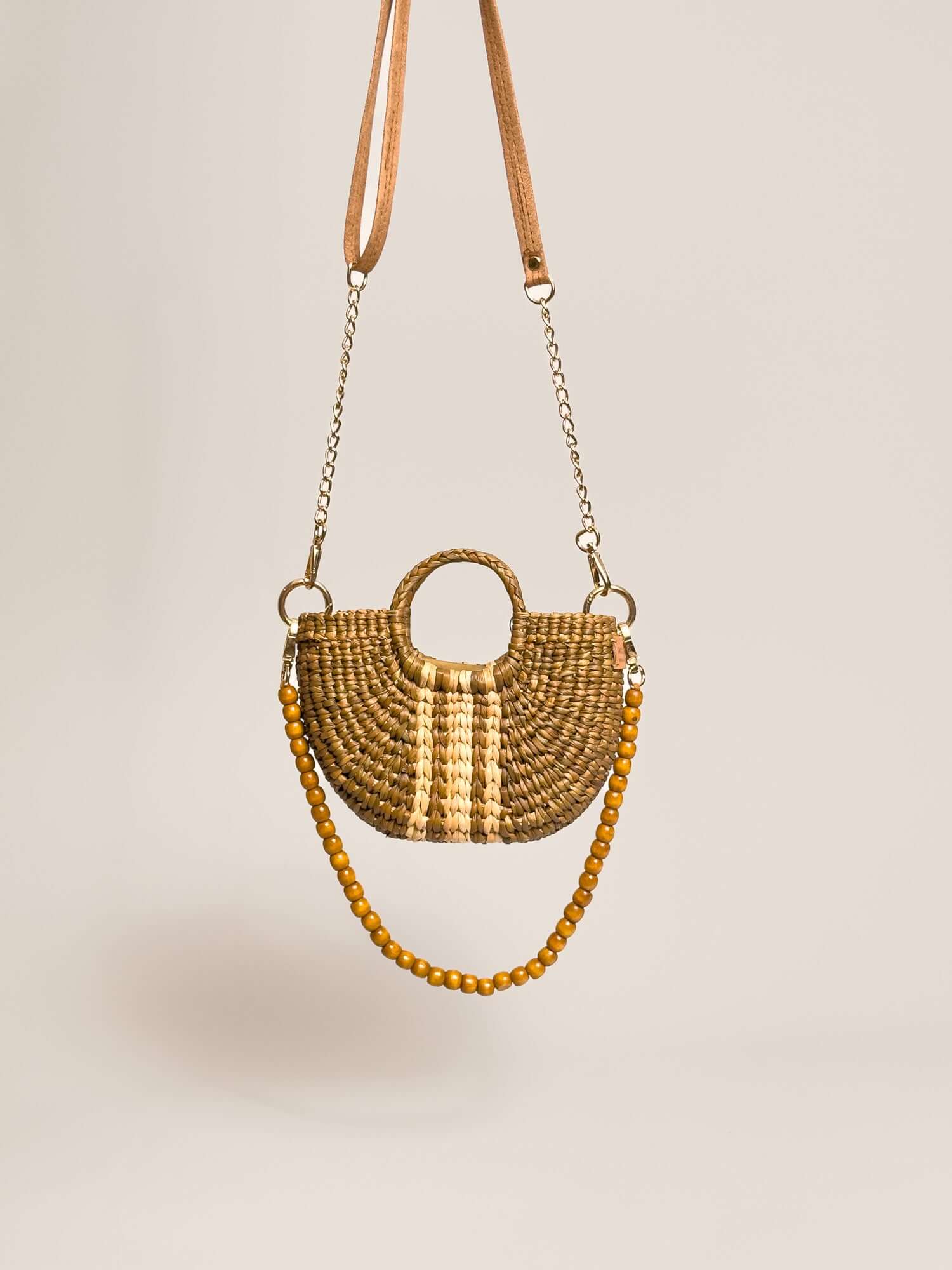 The Fiesta Mini Deluxe - Sage with Natural Band, handwoven junco crossbody bag with wooden beads strap and chain accents.