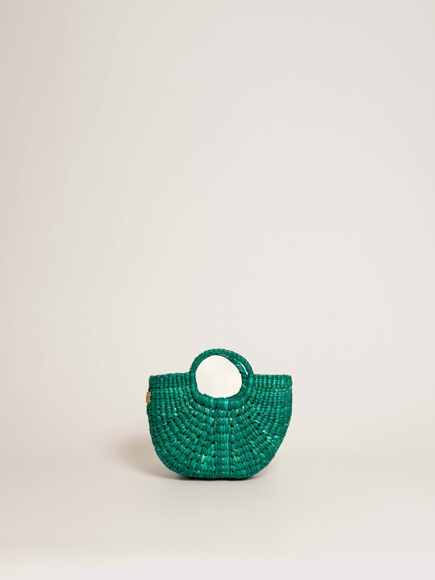 The Fiesta Mini Deluxe - Turquoise handwoven junco crossbody bag, green colour, features handles and a round shape.