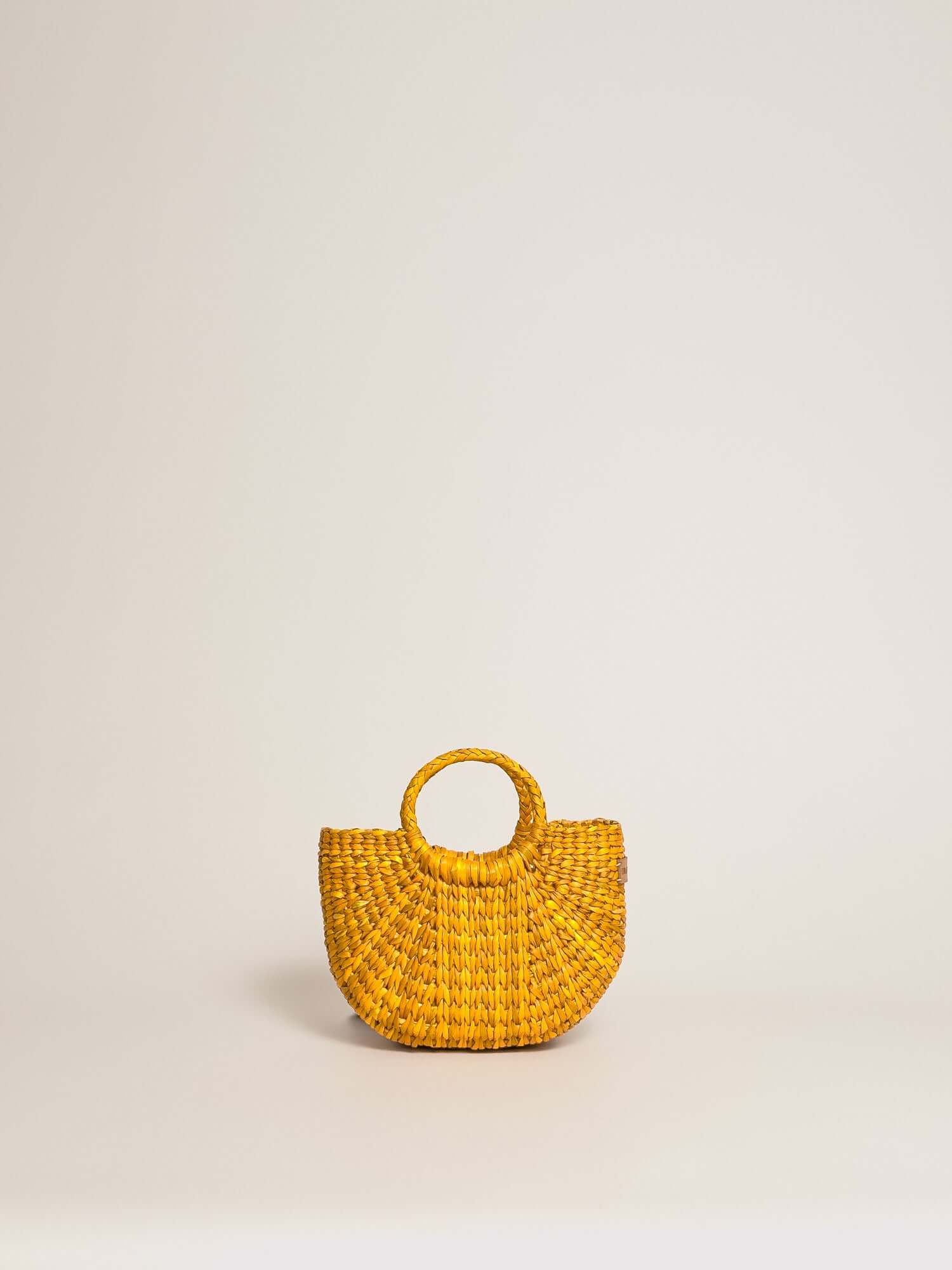 The Fiesta Mini Deluxe - Yellow handwoven junco crossbody bag with round handle and textured woven design.