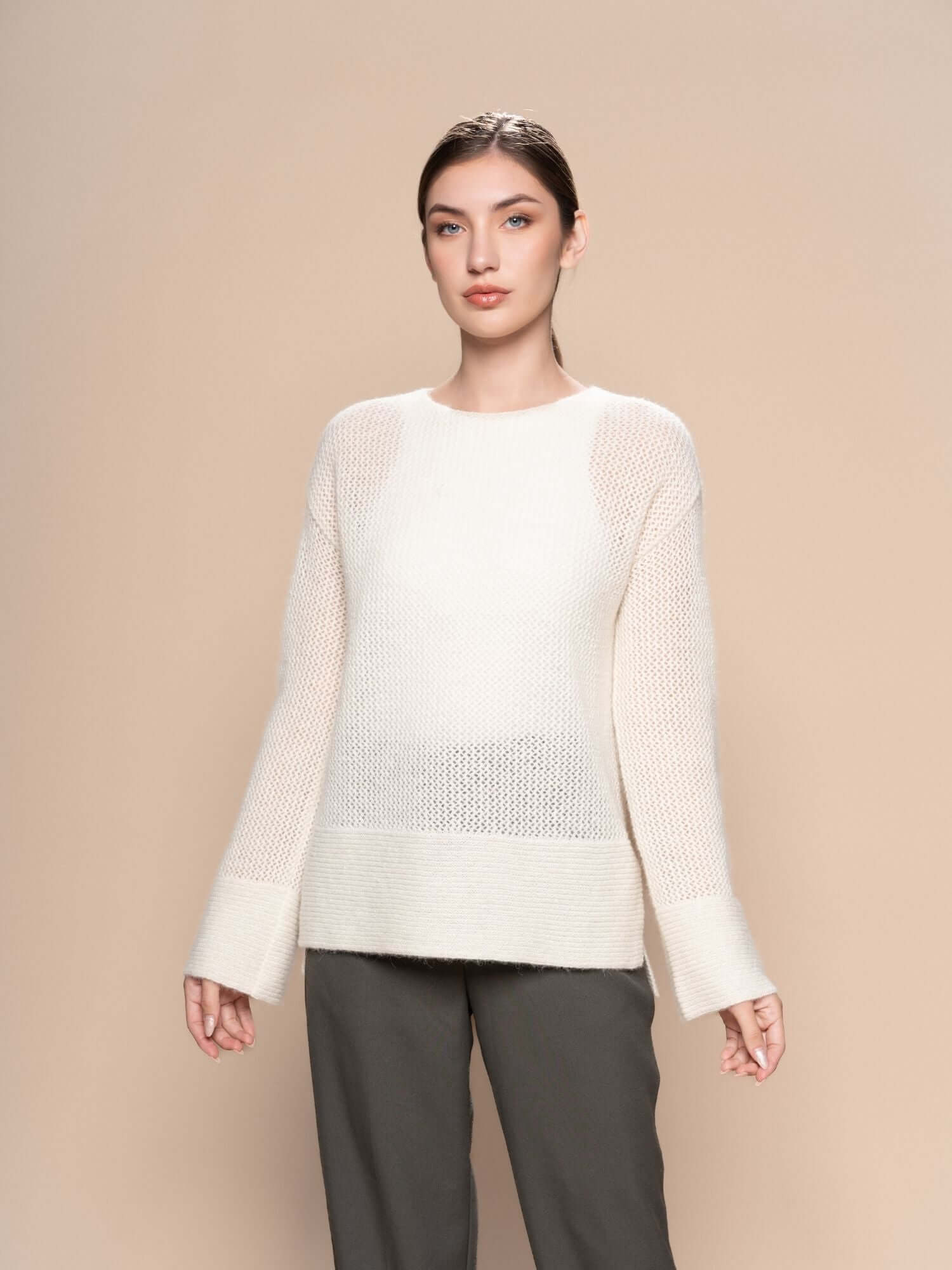 Ivory baby alpaca open knit jumper styled with wide-leg natural trousers