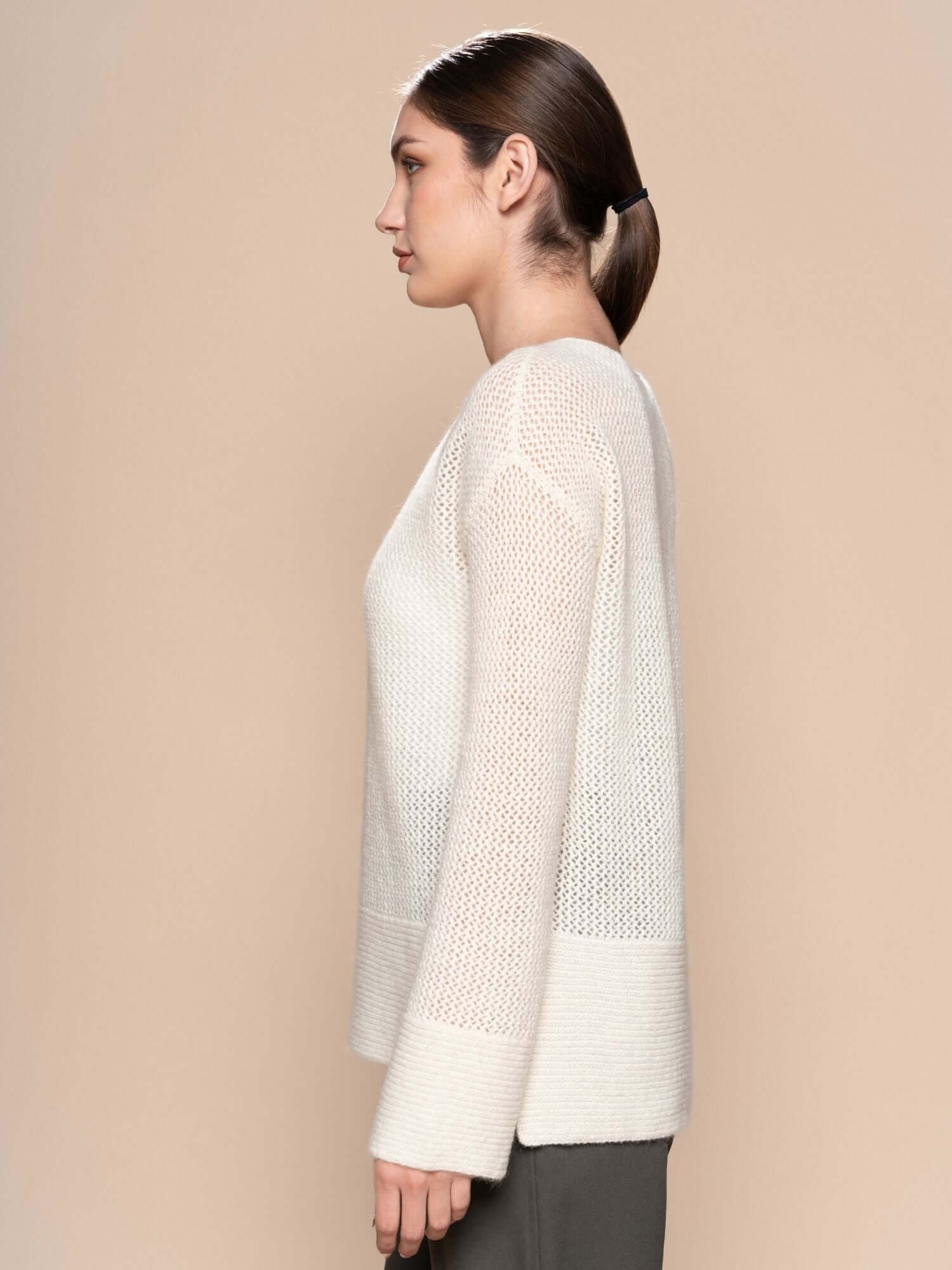 Side view of ivory baby alpaca jumper showing relaxed fit and long back hem