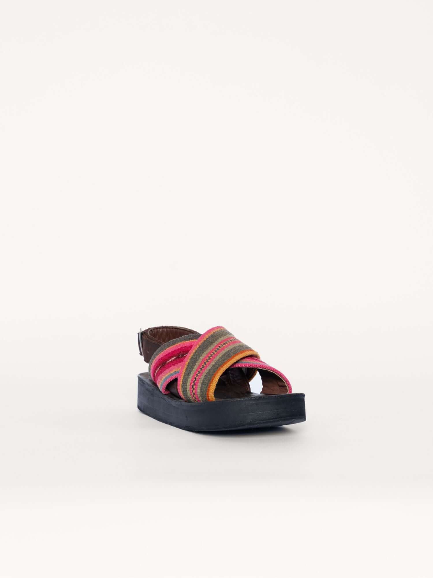 Handcrafted wool and leather x sandals in green and pink, front diagonal view.