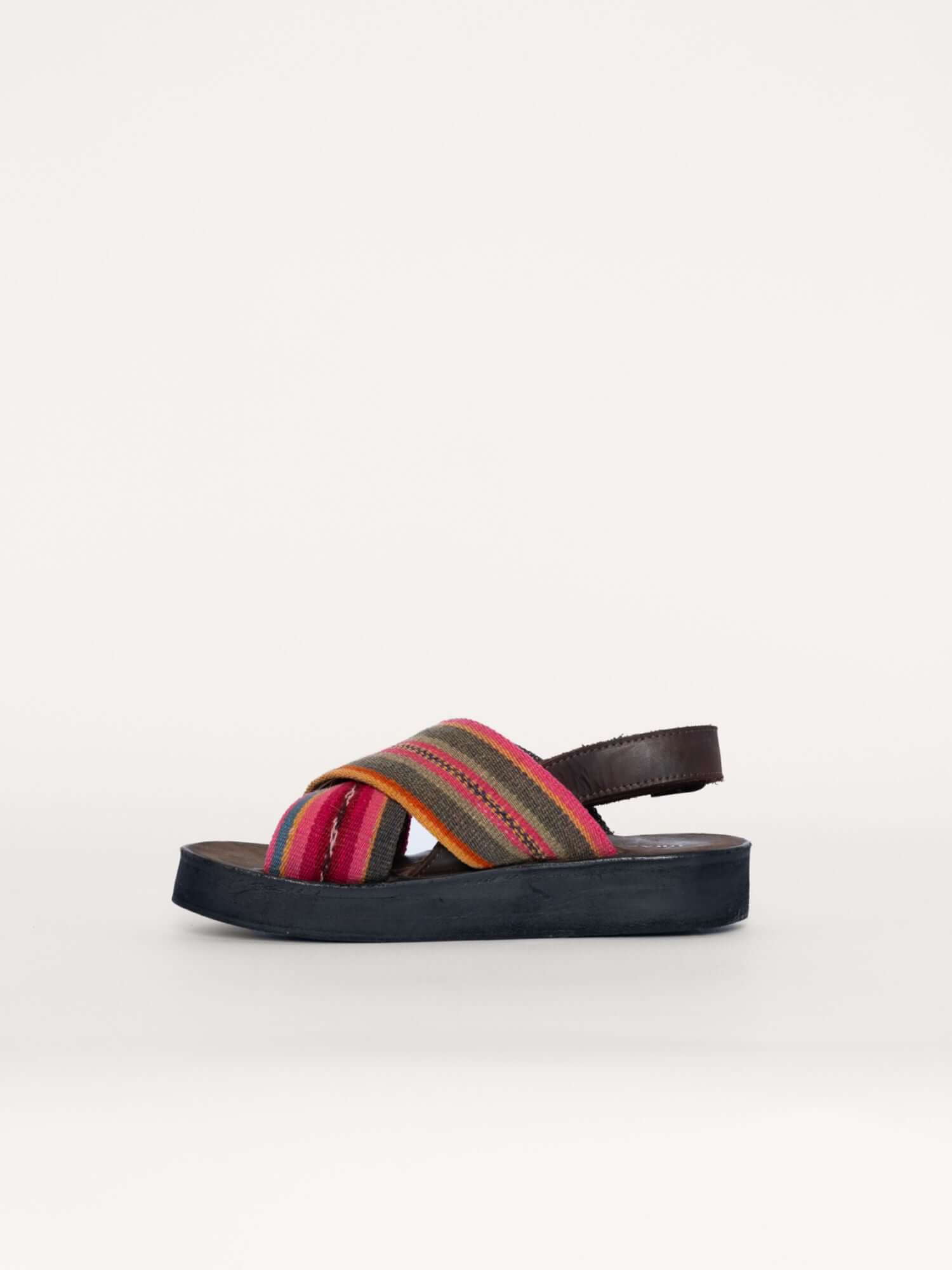 Handwoven green and pink wool x strap sandals for women and men, left side view.