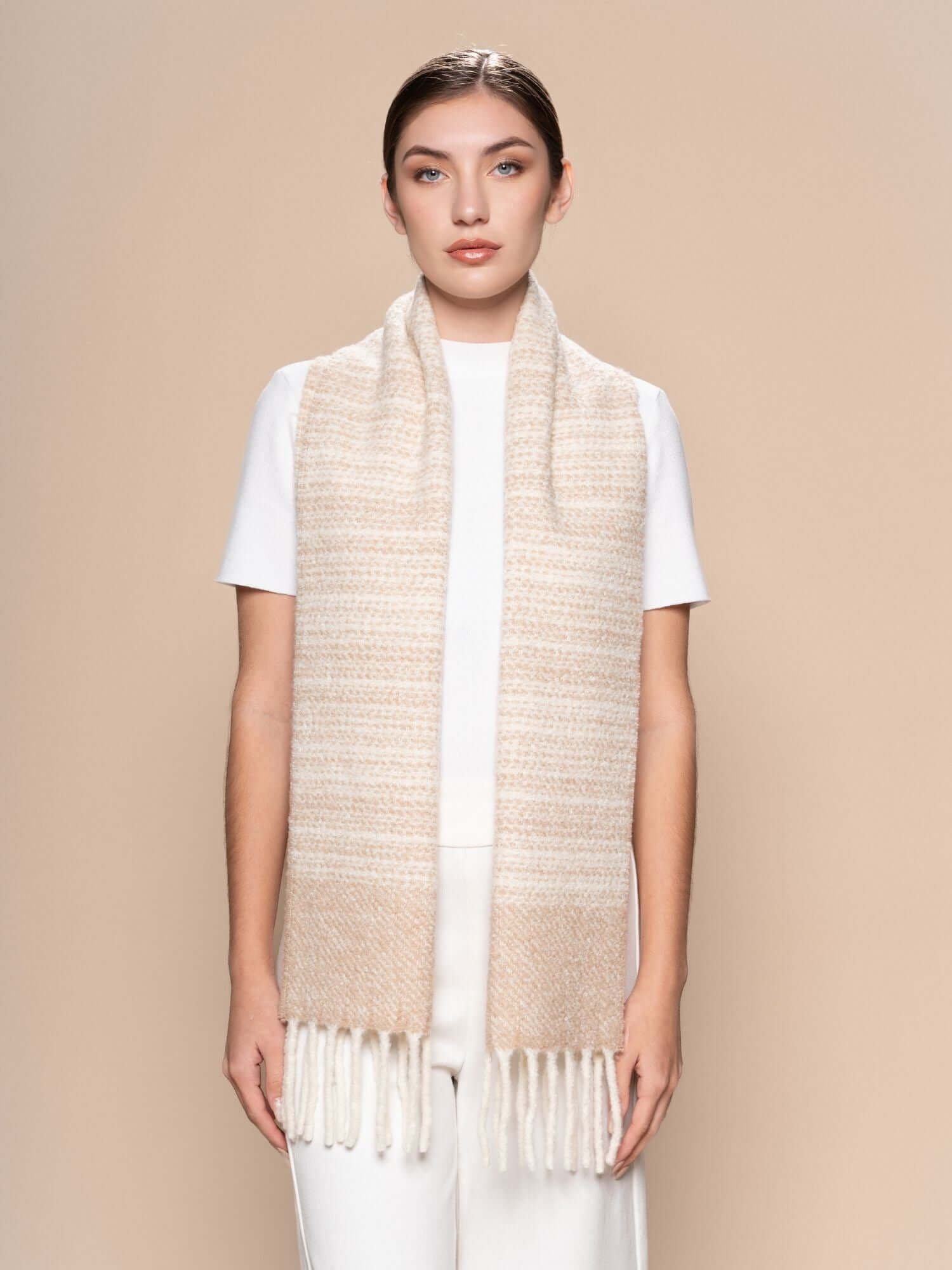 Model showing bouclé scarf styled long, striped alpaca and wool blend for winter layering