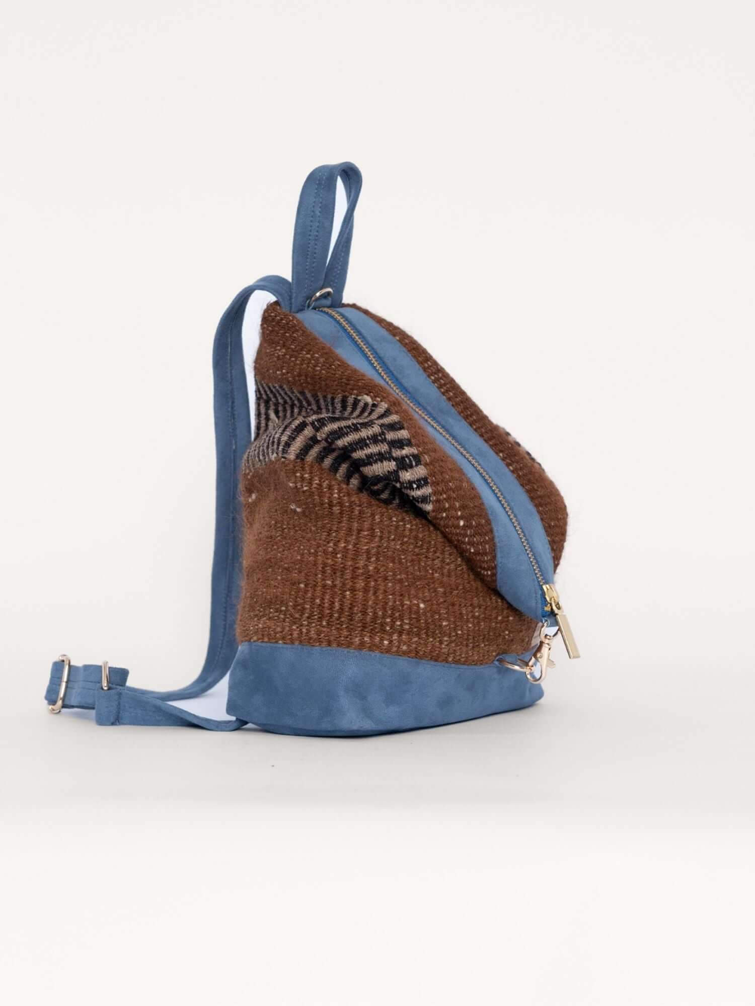 Side view of handmade wool backpack with suede body – structured and stylish for everyday or travel use
