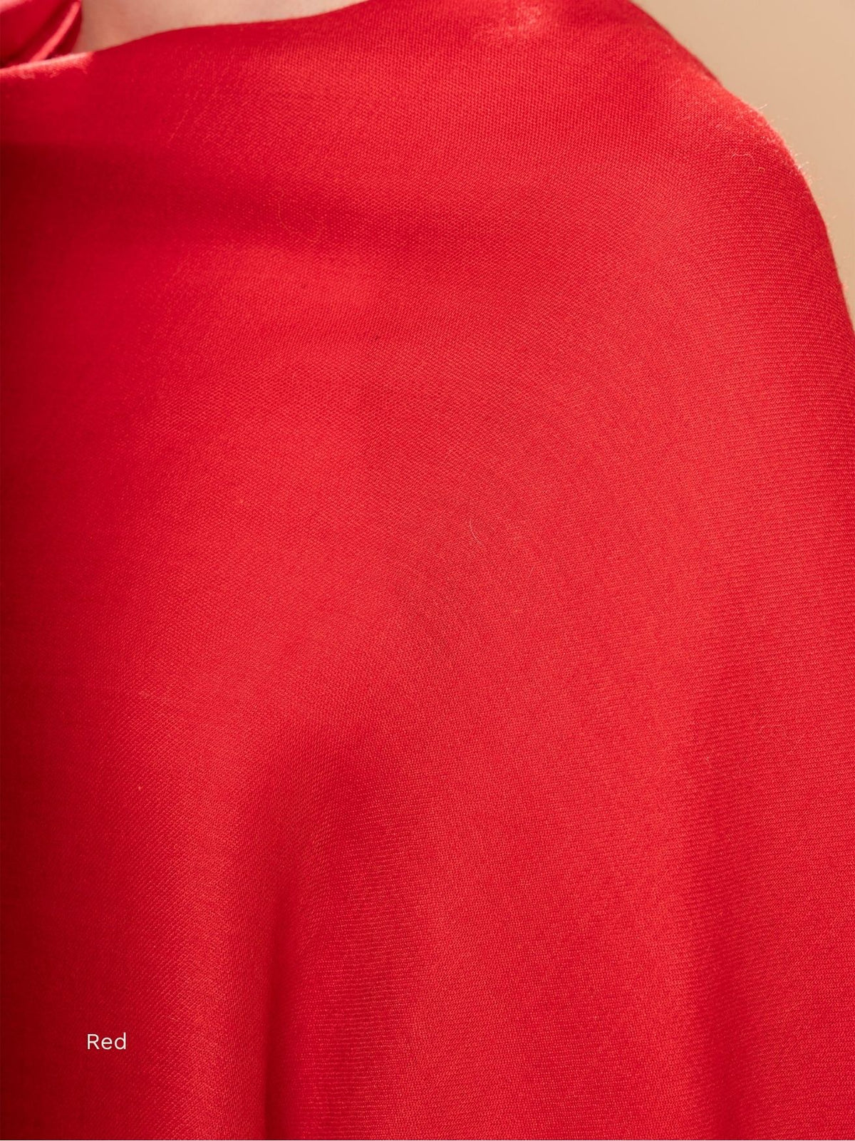 Red silk baby alpaca blend shawl, close-up of the smooth fabric draped over the shoulder