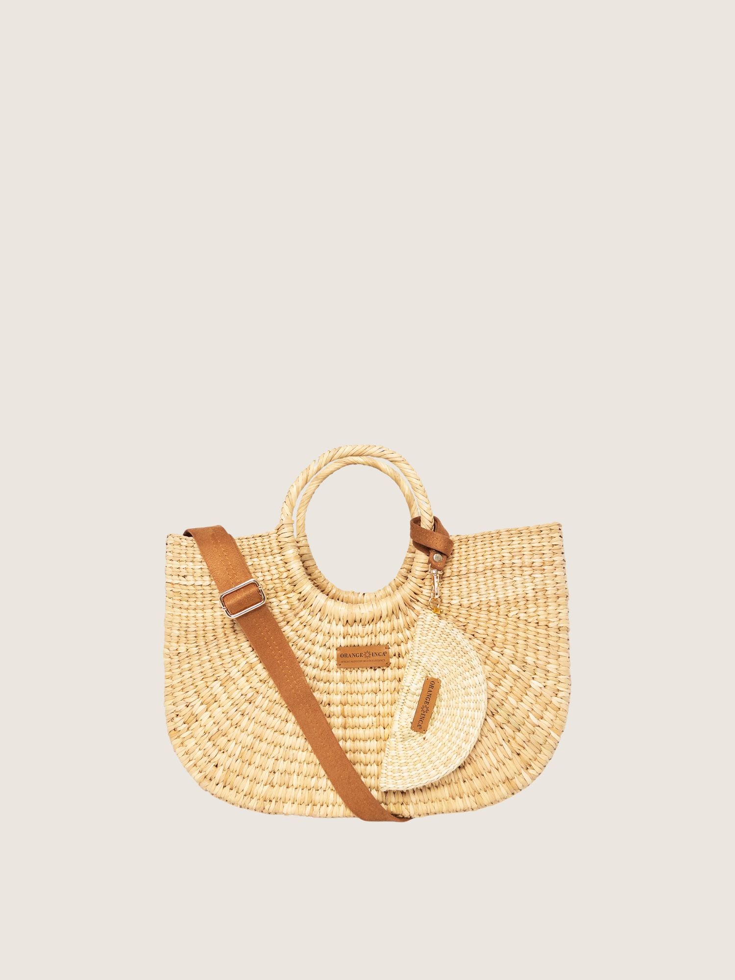 Gran Fiesta Crossbody Tote - Natural, handwoven junco tote bag, spacious, structured handbag with brown handles and adjustable strap.